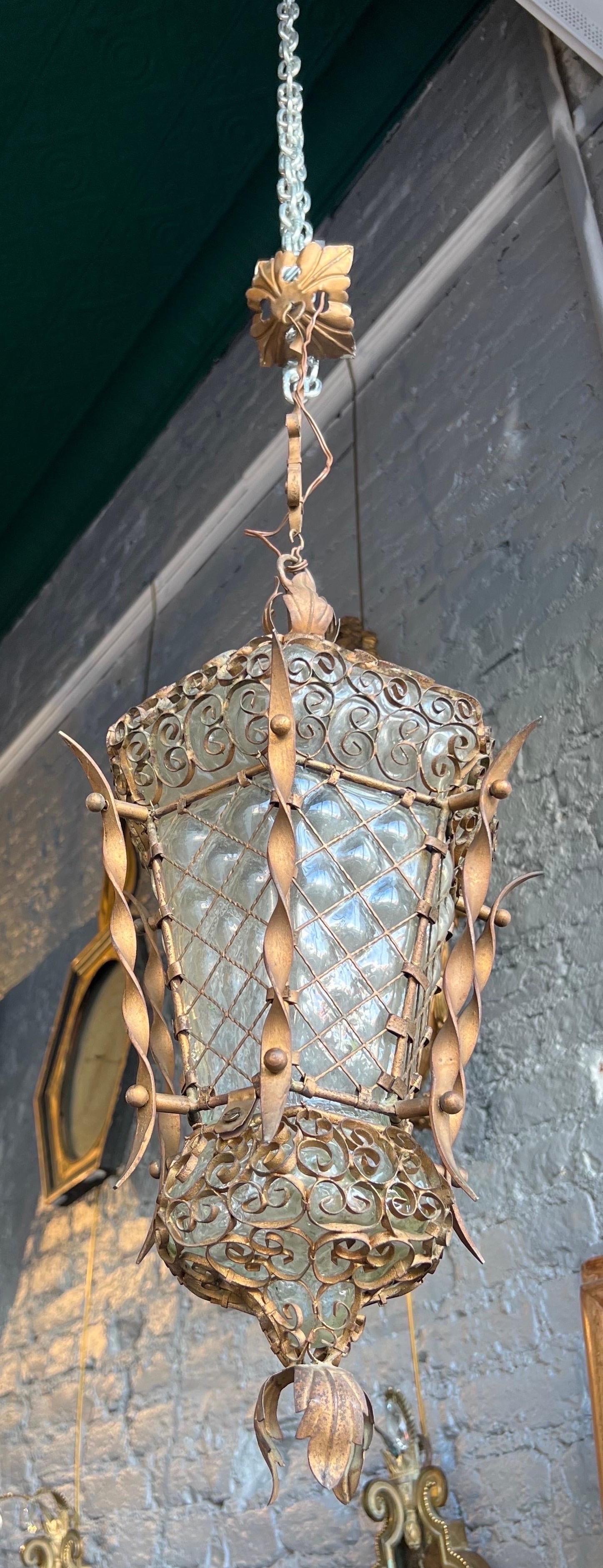 Great little Venetian blown glass and iron lantern dating from the end of the 19th century to the beginning of the 20th century. The ironwork is hand fit around the blown glass lantern. Recently rewired for electricity. Would be wonderful in a