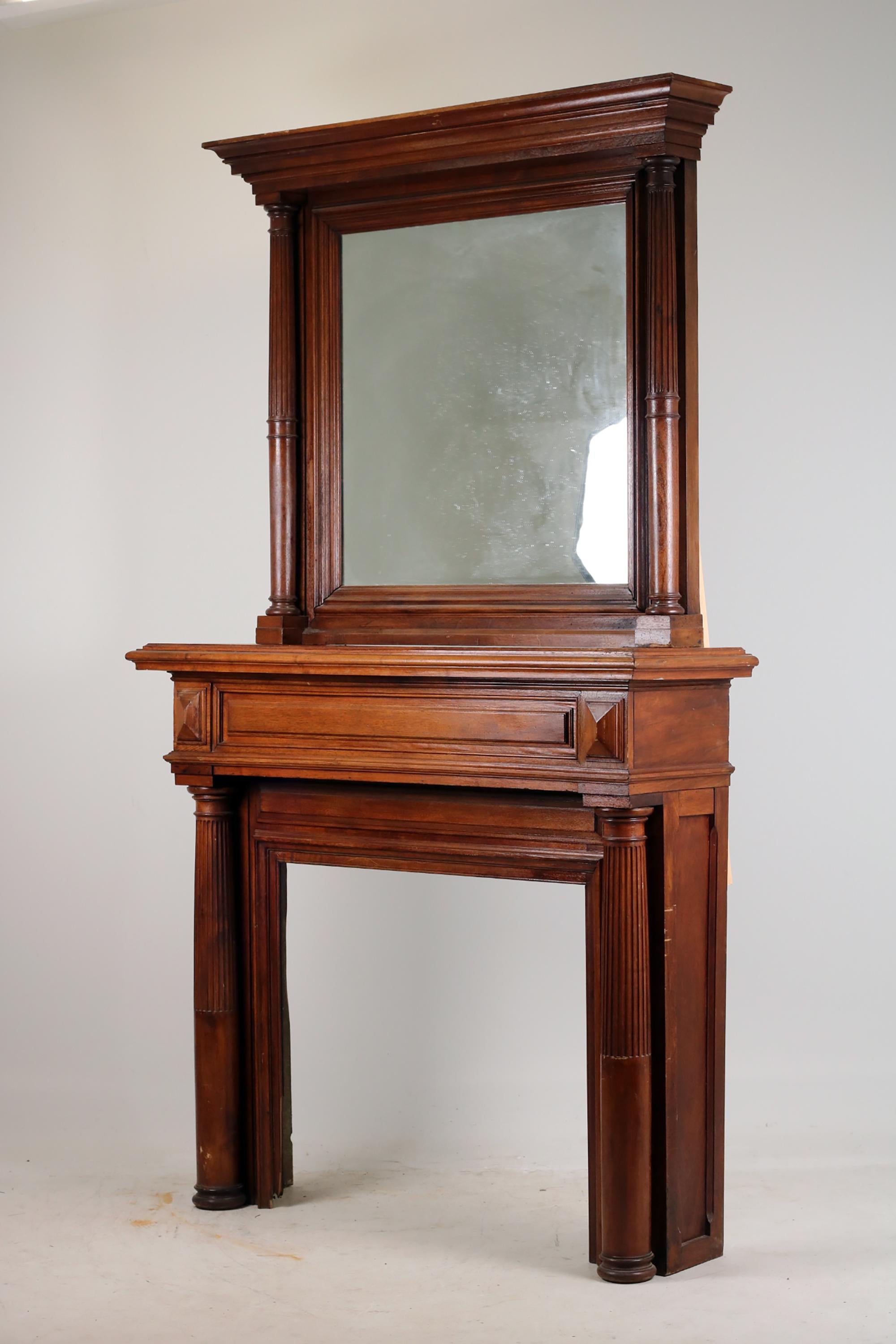 Neoclassical Fireplace, 
Ca.1890-1900
Solid oak

Antique Neoclassical Fireplace Mantel made with solid oak wood with frame with mirror. The fireplace and frame with mirror are two separate elements. 
In the lower and upper part, Doric columns with