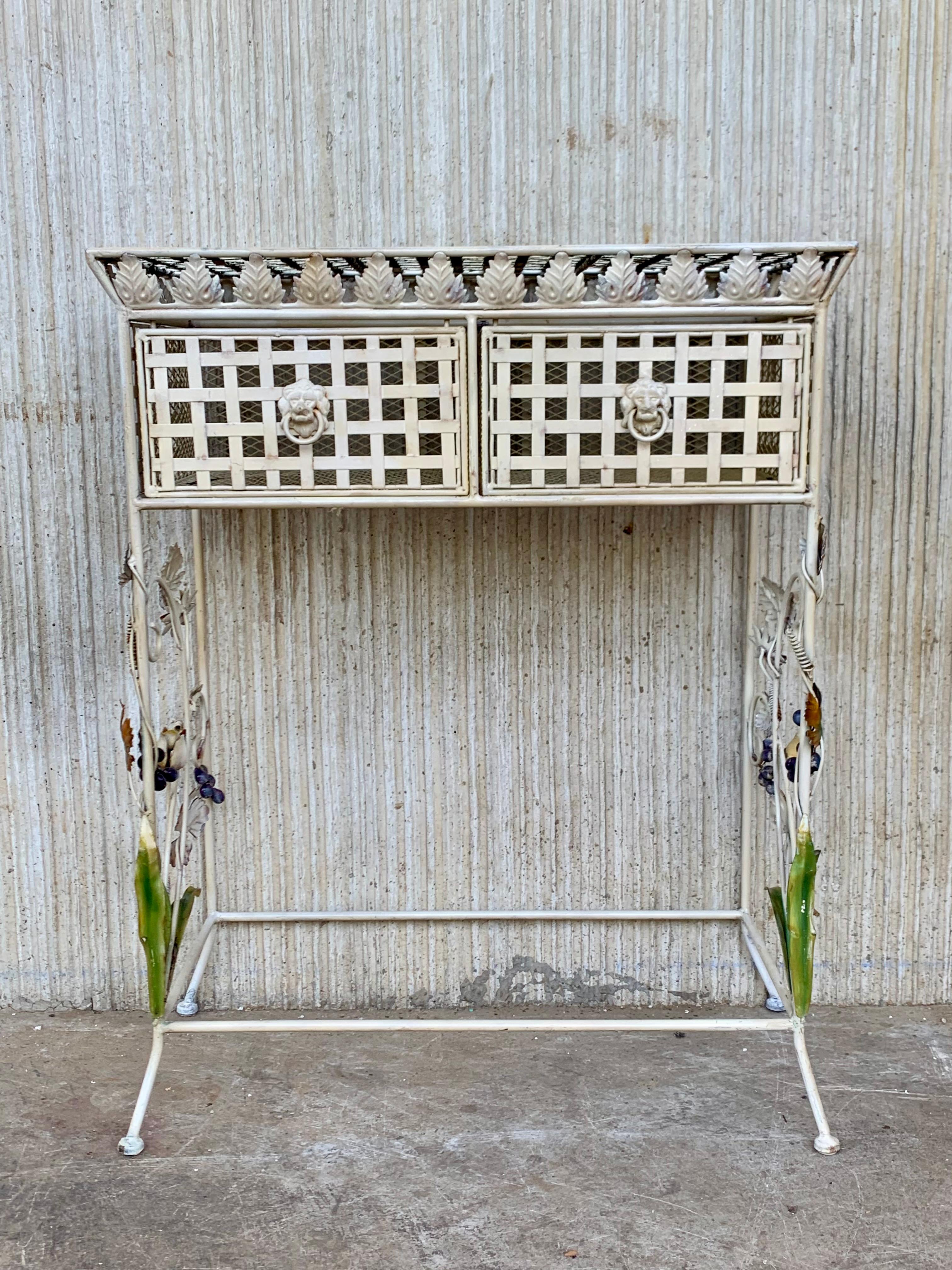 This is a chic French or Spanish late-19th century Forged iron console with two drawers. 
The side are decorated with ornamental flowers handprinted.
The iron has the corrosion wear of the time.
 This table would add a sculptural feel to any
