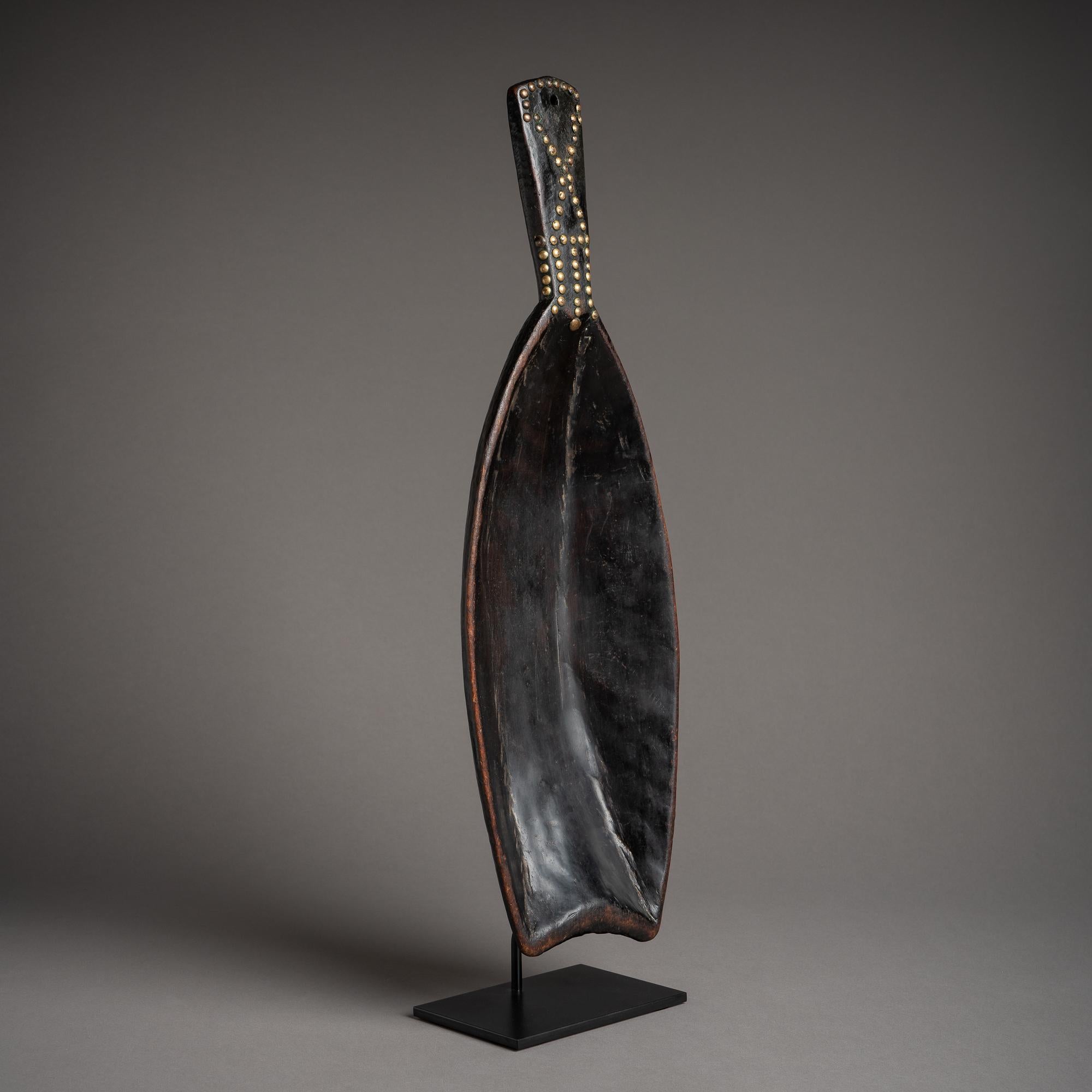 Prestige spoons are an artistic convention across Africa, and not least in the Congo, where this magnificent Mongo example was carved. With long, gently swelling flanks, a slightly wedge-shaped handle, and its concave, double-pointed tip, this