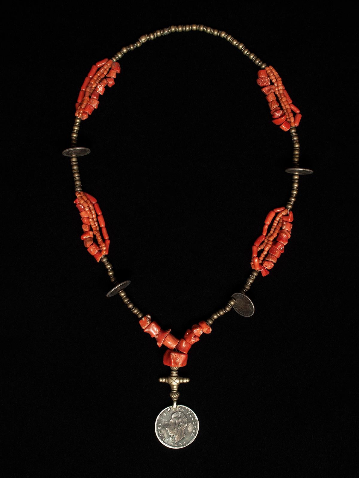 Late 19th to Early 20th Century Coral and Silver Necklace, Ecuador

A classic coral necklace from Ecuador, with a central sucre coin marked Republica del Ecuador 1884, which was named after Latin American political leader Antonio José de Sucre.