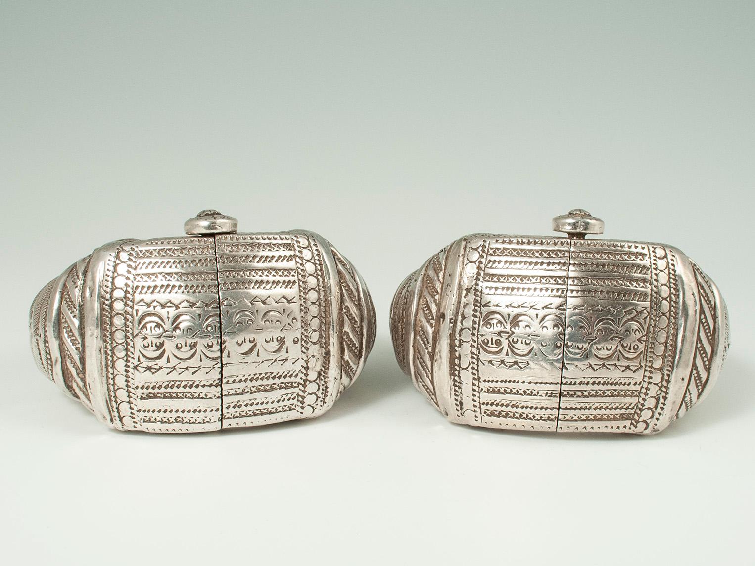 Late 19th to early 20th century silver Anklets, Oman

These silver anklets were fashioned in India for the Omani market. Made of repousse silver over a wood frame, they open with a central screw pin. This pair is in wonderful worn condition - an