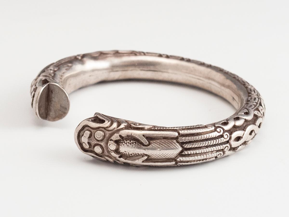 Late 19th-early 20th century silver bangle dragon bracelet, China

A wonderful hollow silver repousse bracelet with a double headed dragon/serpent and scroll work. There is a Chinese character hallmark stamped near the neck of one dragon. It