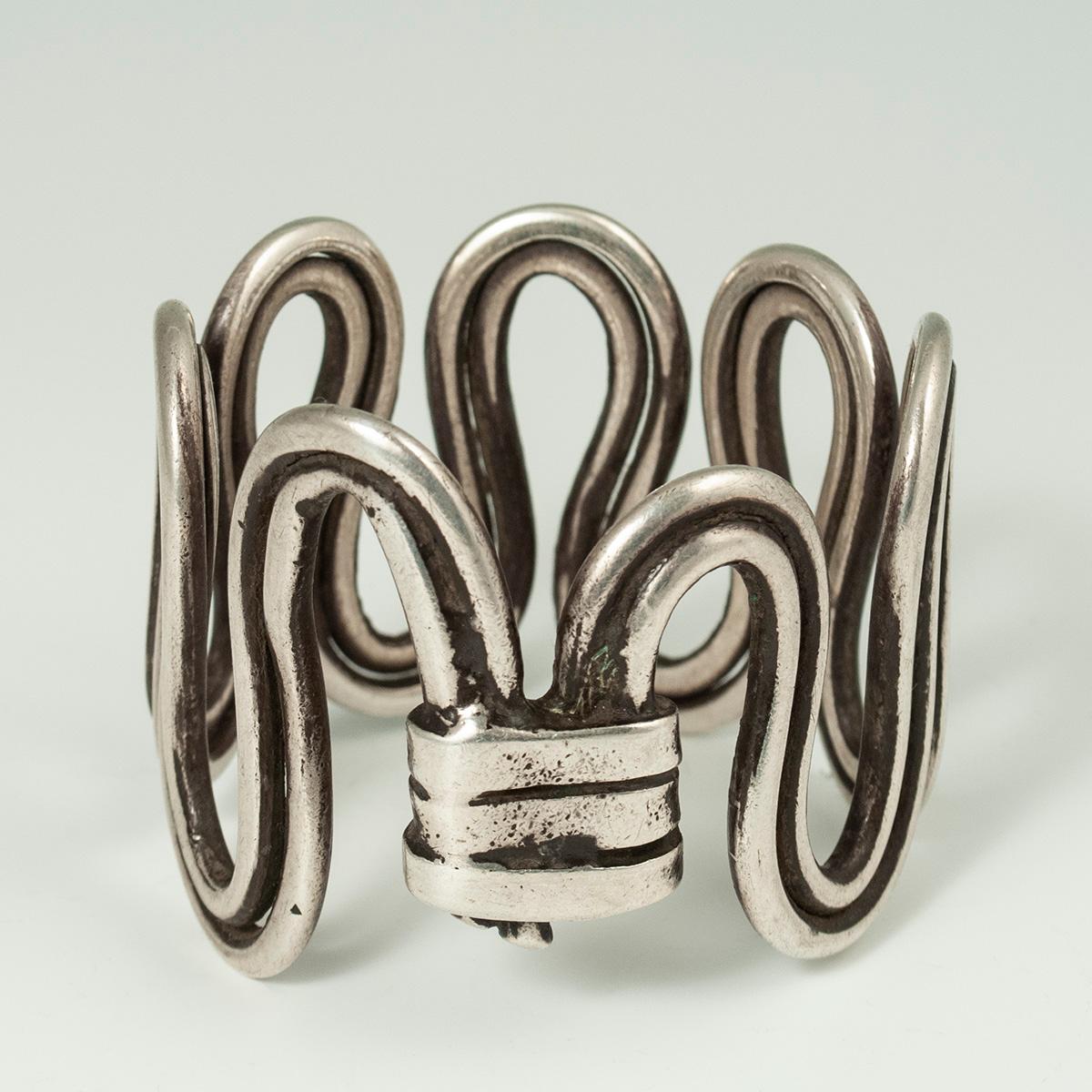 Late 19th to Early 20th Century Silver Wire Serpent Bracelet, Rajasthan, India

A substantial silver cuff made of wire bent in the shape of a serpent, these bracelets were worn on the upper arm by women in Rajasthan. It measures 7.5 inches (19 cm)