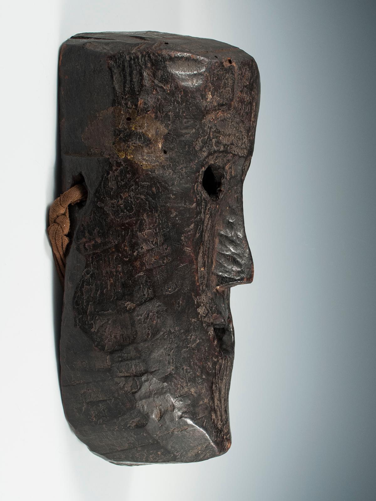 Late 19th-early 20th century Tribal mask, Middle Hills, Nepal

With a somewhat unconvincing smile, the expression on this mask is ambiguous yet powerful. It is large mask, with a prominent forehead and wonderful patina. There is a greenish-yellow