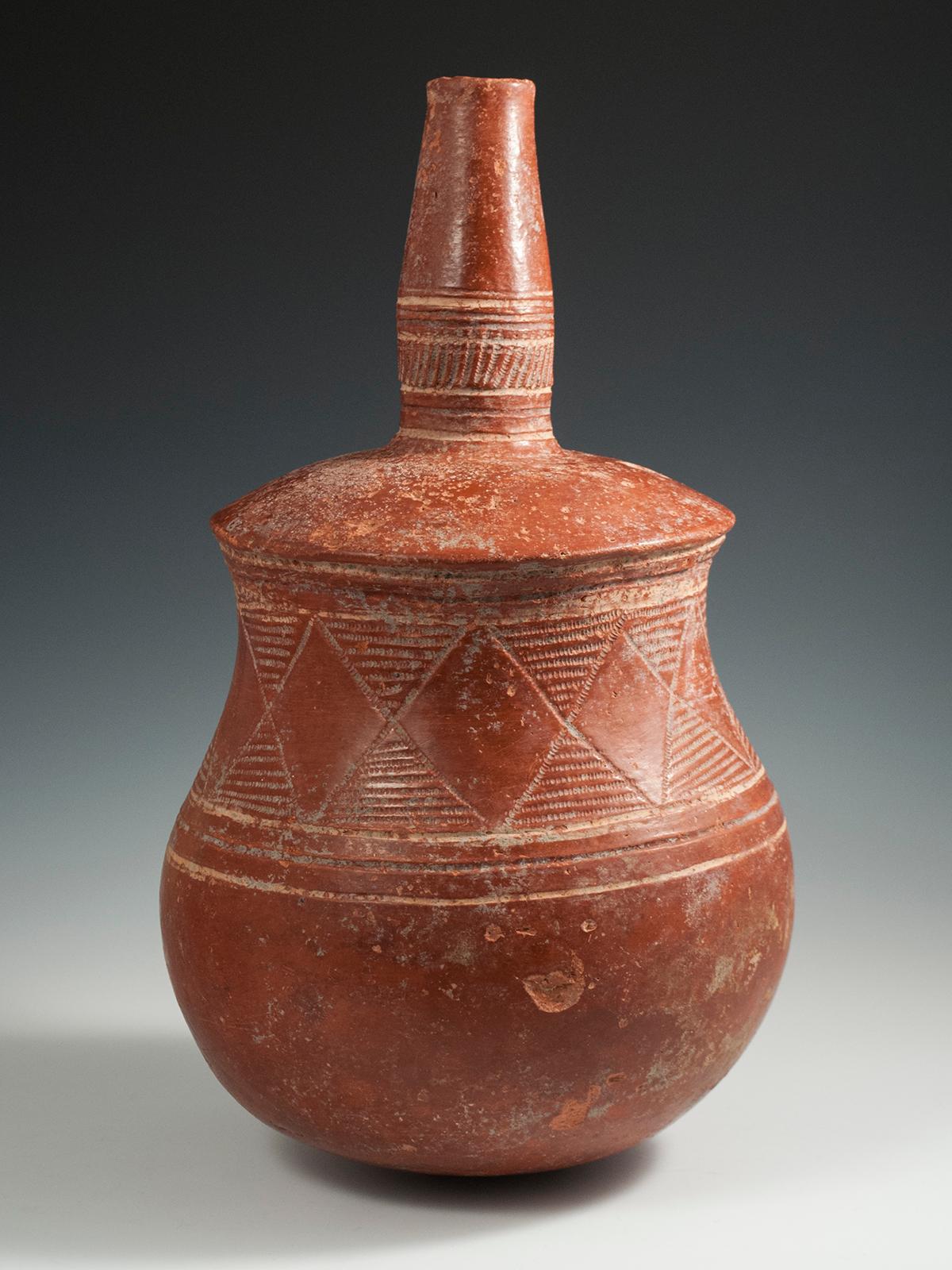 Late 19th-Early 20th century tribal terracotta bottle, Djenne Area, Mali

A handsome terracotta bottle from the Djenne area of Mali with incised geometric patterns on the globular body and incised rings around the neck. There are a few rim chips