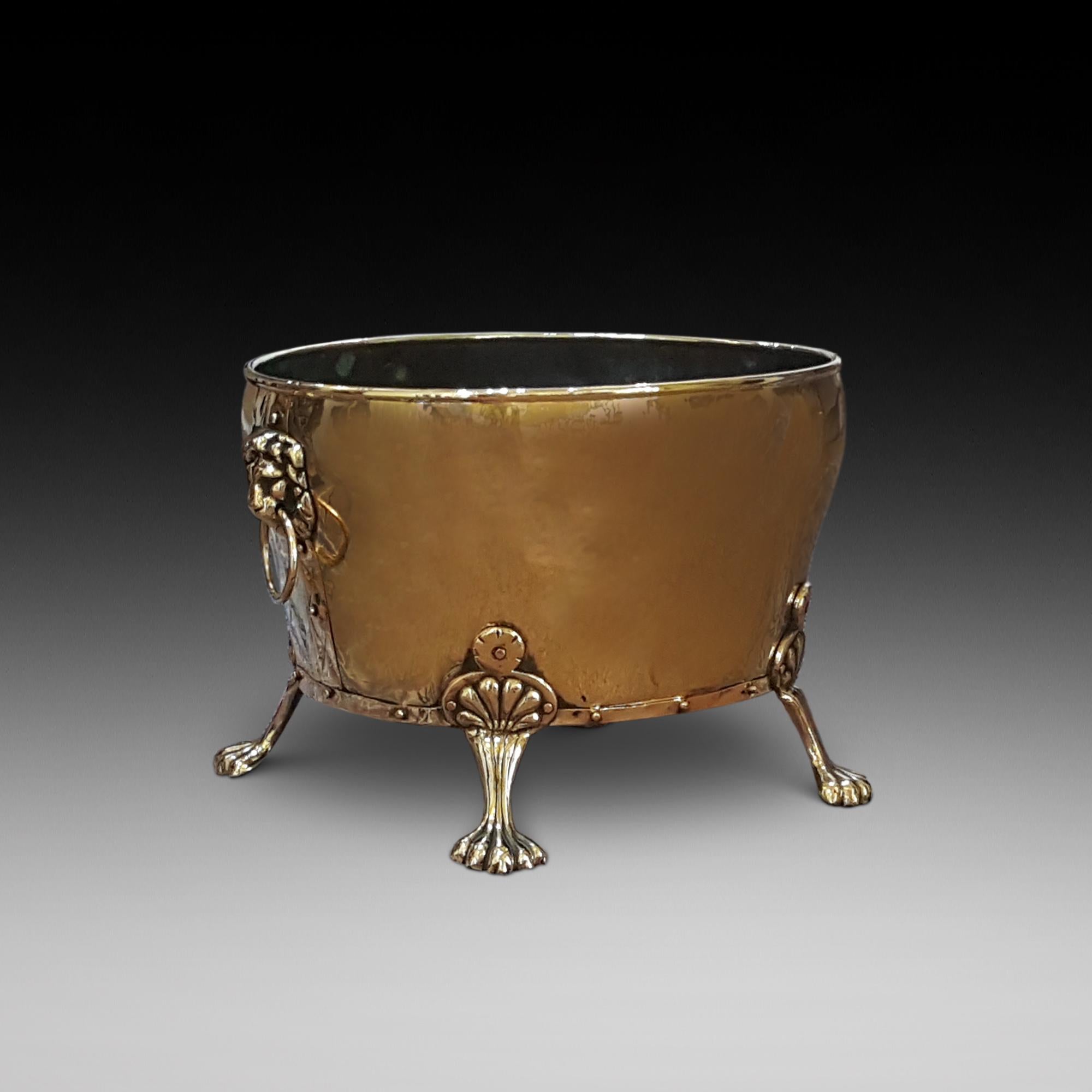 Late 19th century brass log bucket with lion head handles on paw feet 19