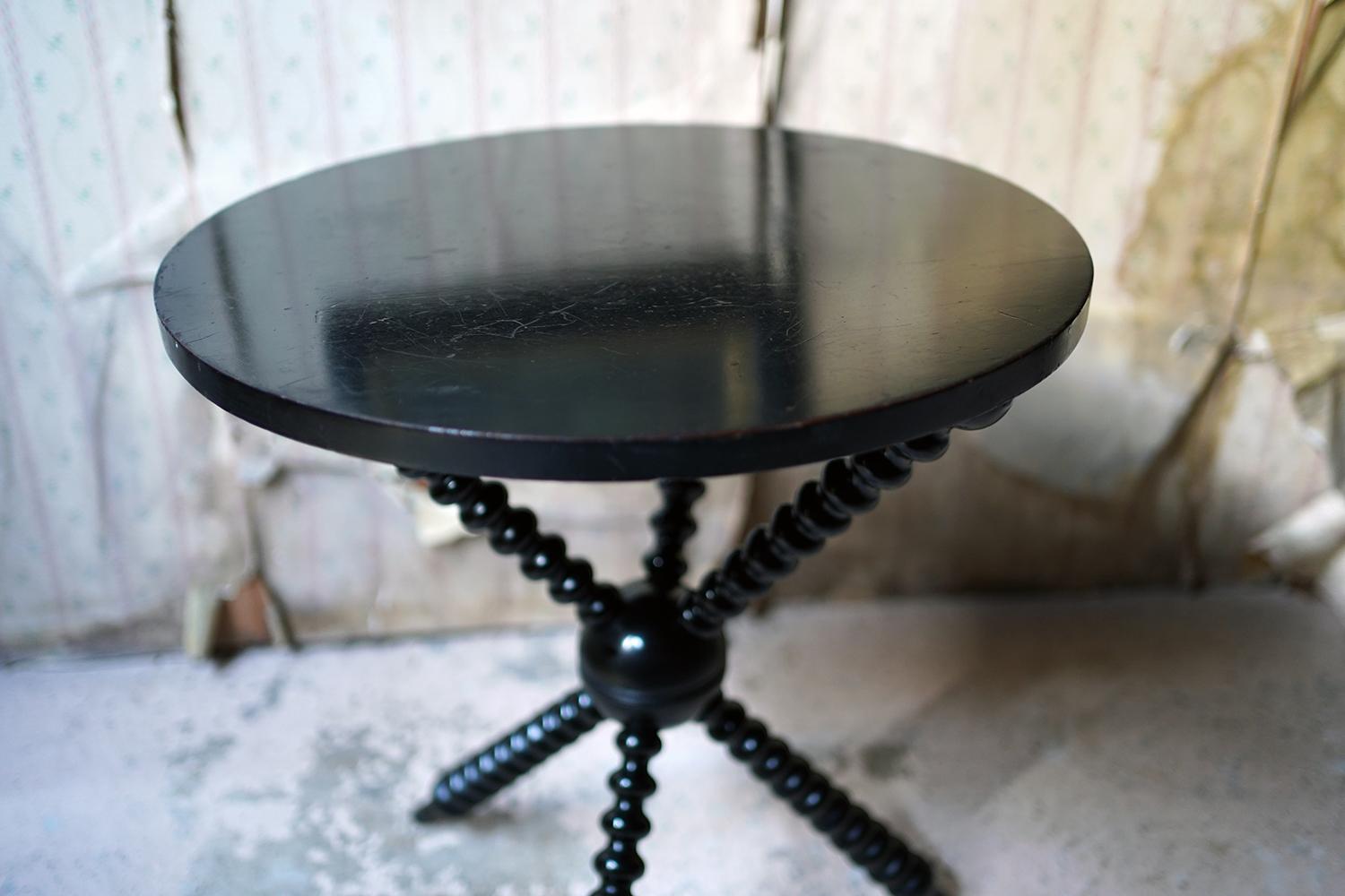 The super quality ebonized bobbin side or gypsy table, stamped under for Wylie & Lochhead Glasgow and the number 76318, having a beautifully turned bobbin tripod base to central orb and circular top and surviving from late 19th century,