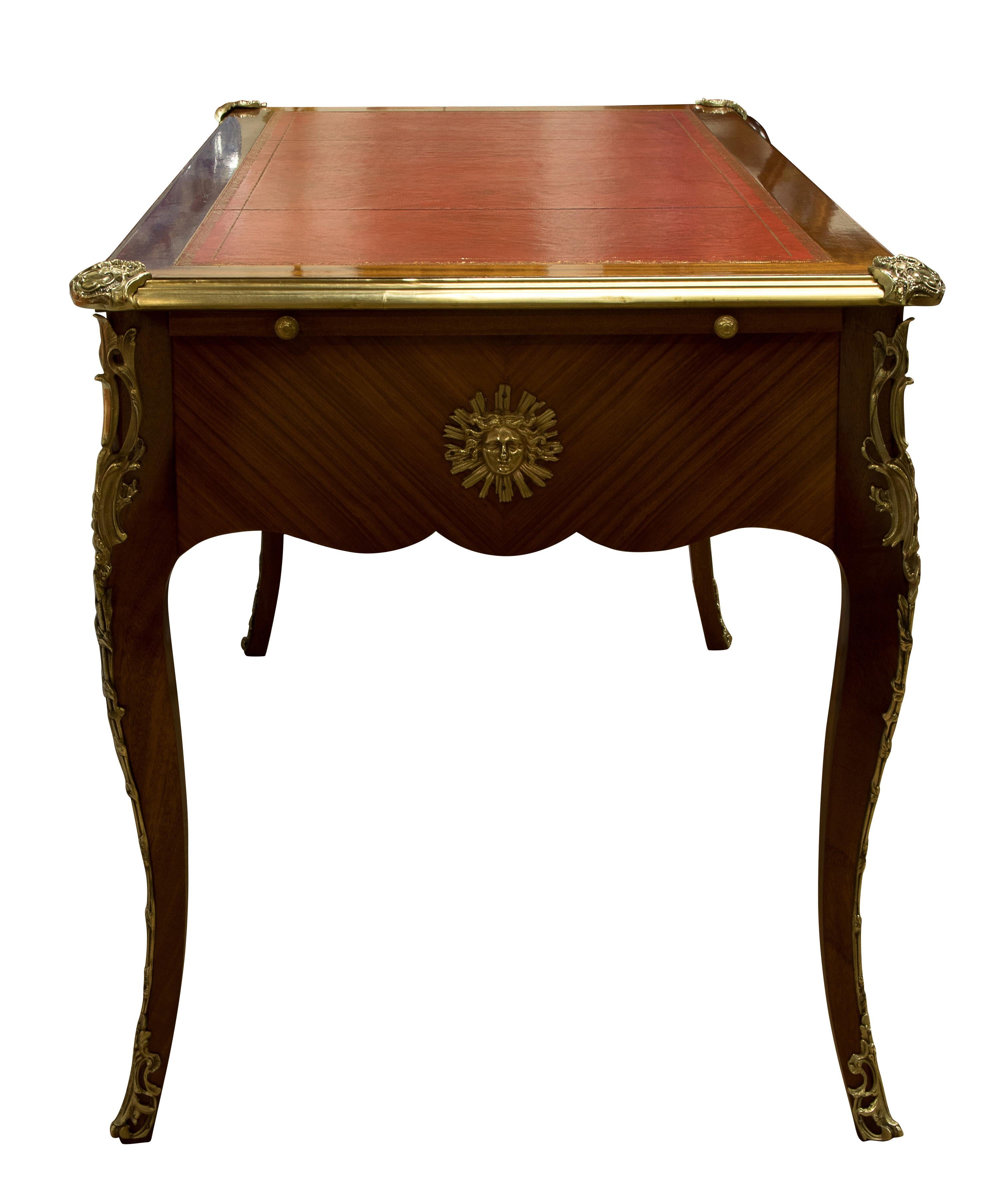 Late 19th century French Tulip wood and mahogany bureau-plat with gilt tooled leather skiver.