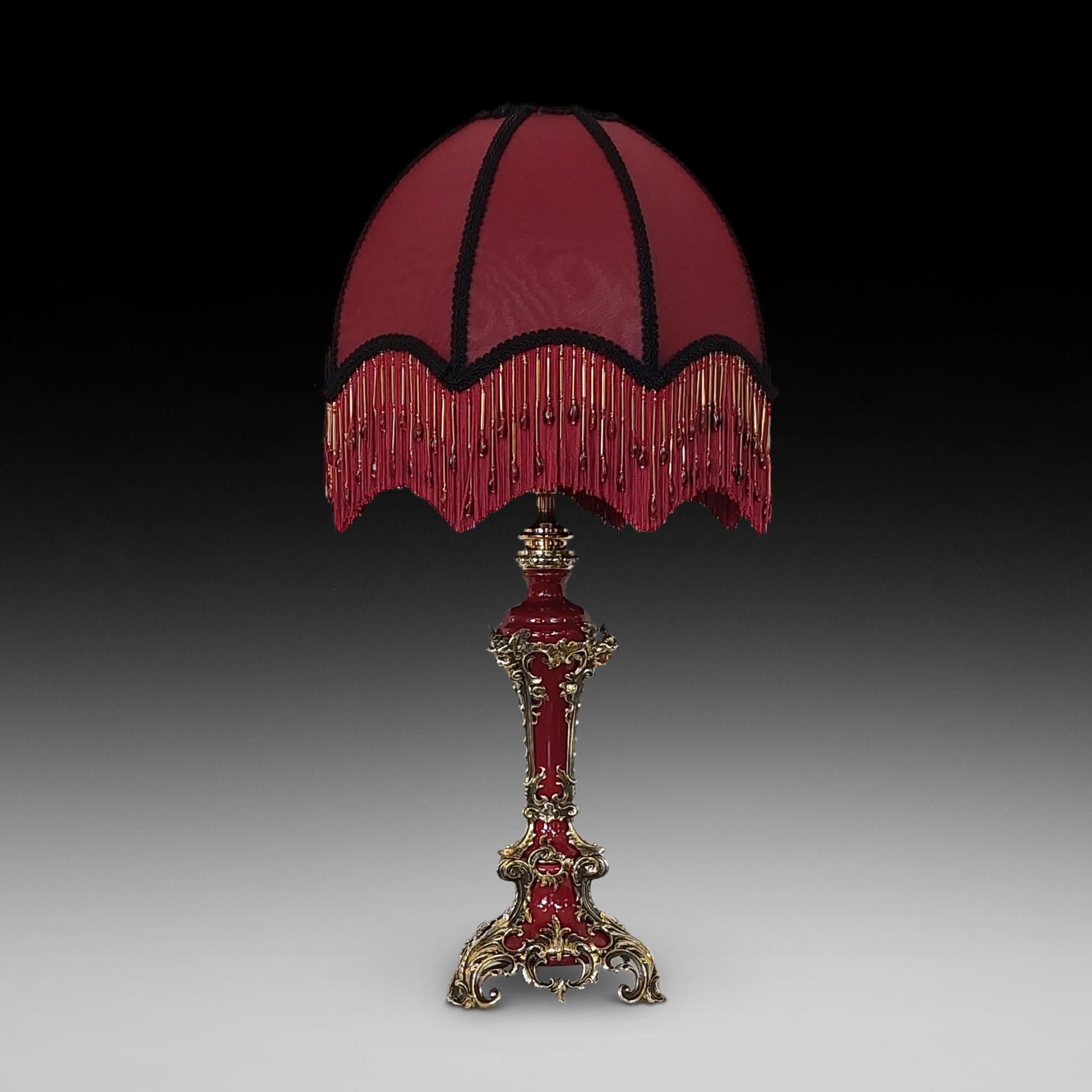 Late 19th century gilt metal mounted table lamp, the burgundy porcelain body of tapering form with applied gilt metal acanthus feet leading to cherub masks - 14