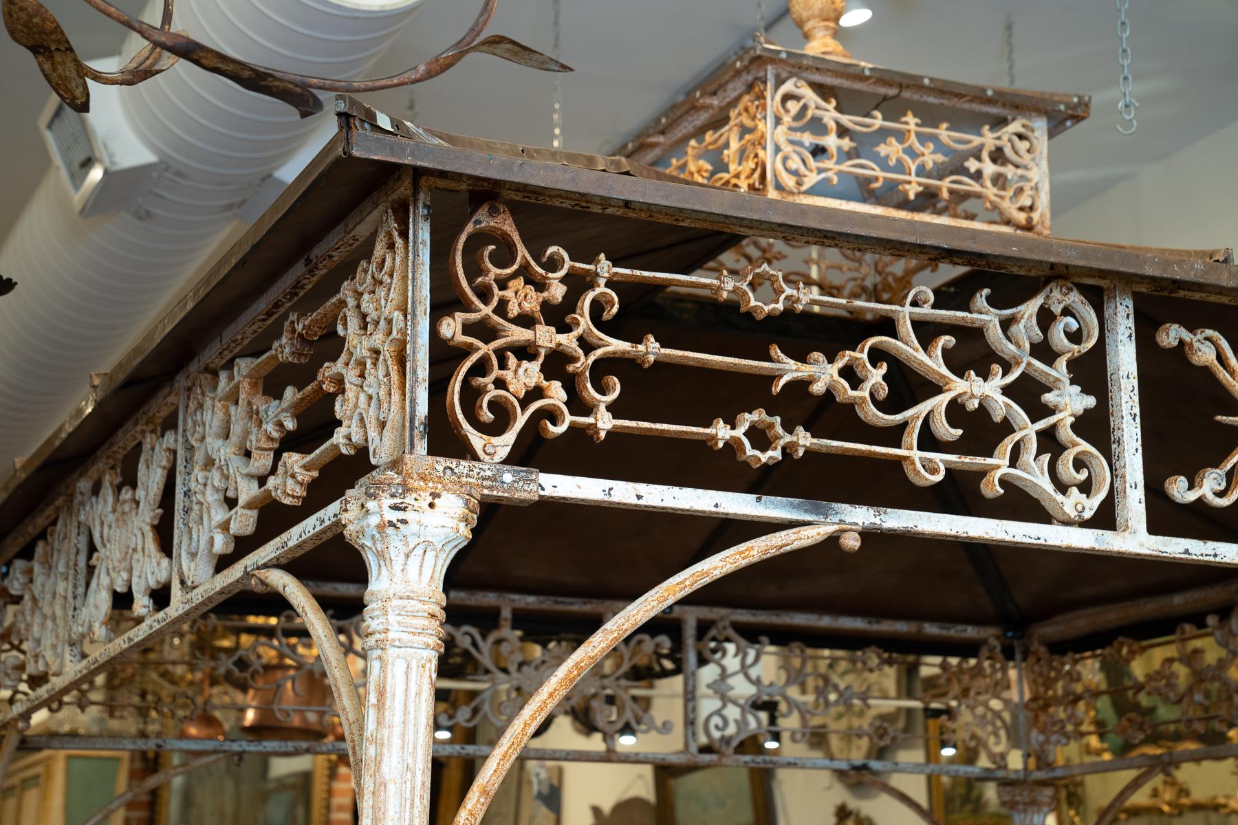 Iron and copper pergola with wonderful details featuring delicate handwrought iron and beautiful copper roofing.