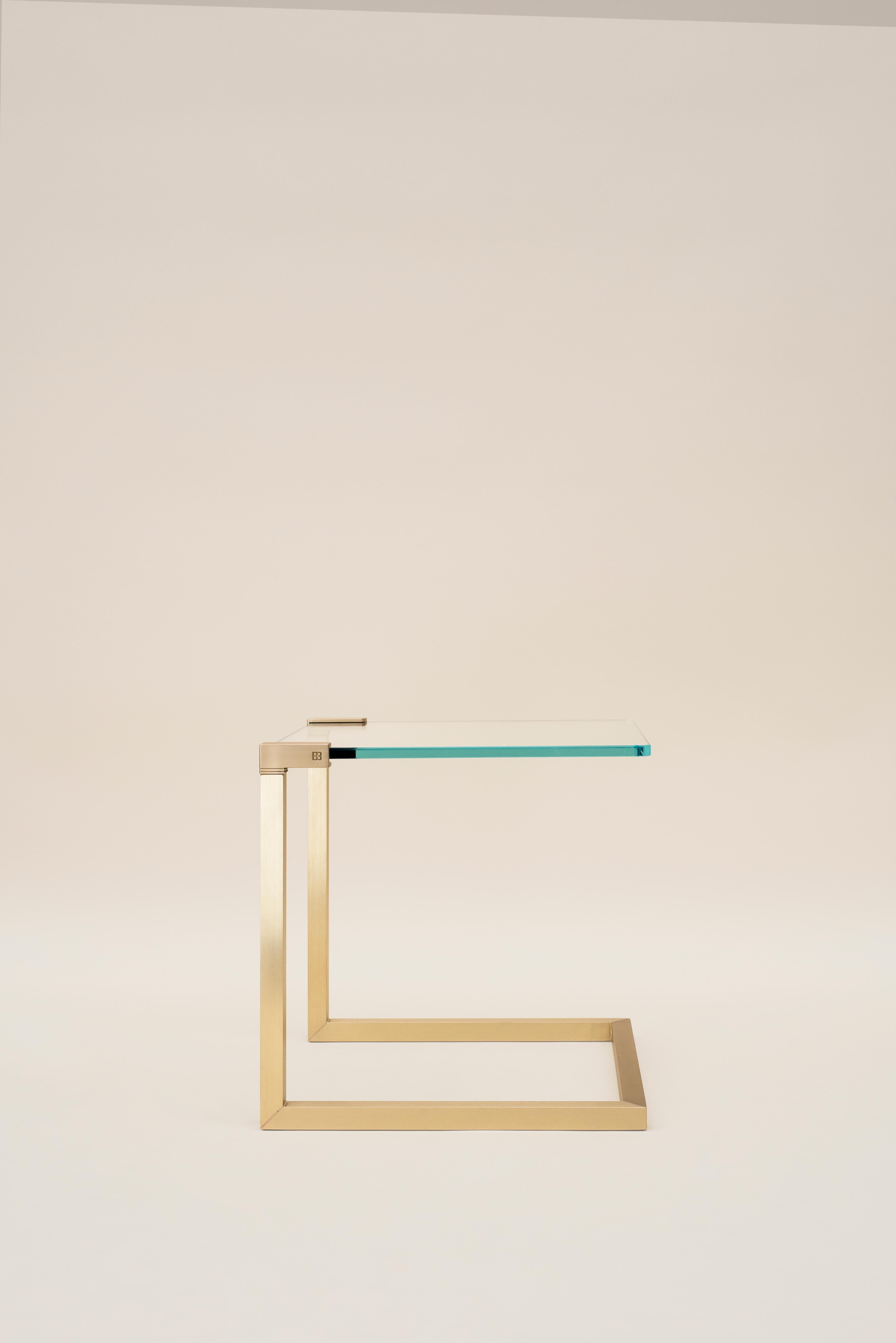 This late 20th century minimalist 'Wil' T53C side table was designed by Peter Ghyczy and hand-crafted in the GHYCZY Atelier in the South of the Netherlands in 1995. The 'Wil' T53C side table features a glass tabletop with a casted polished brass