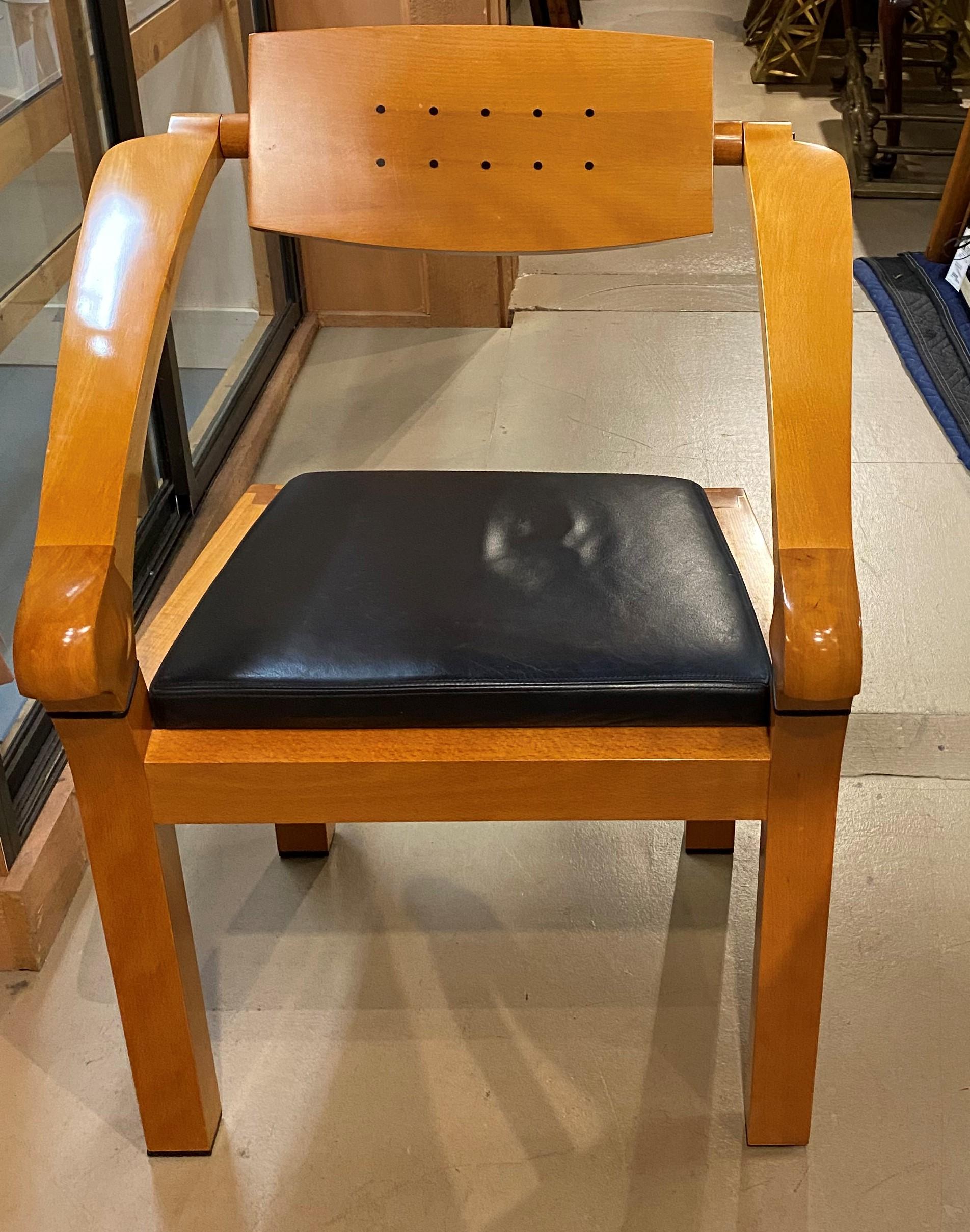 A sleek design spring office chair in polished beech and ebony with leather seat and adjustable back designed by Massimo Scholari for Giorgetti, circa 1990’s. The designer name appears on the Giorgetti brass tag on the underside of the chair, and