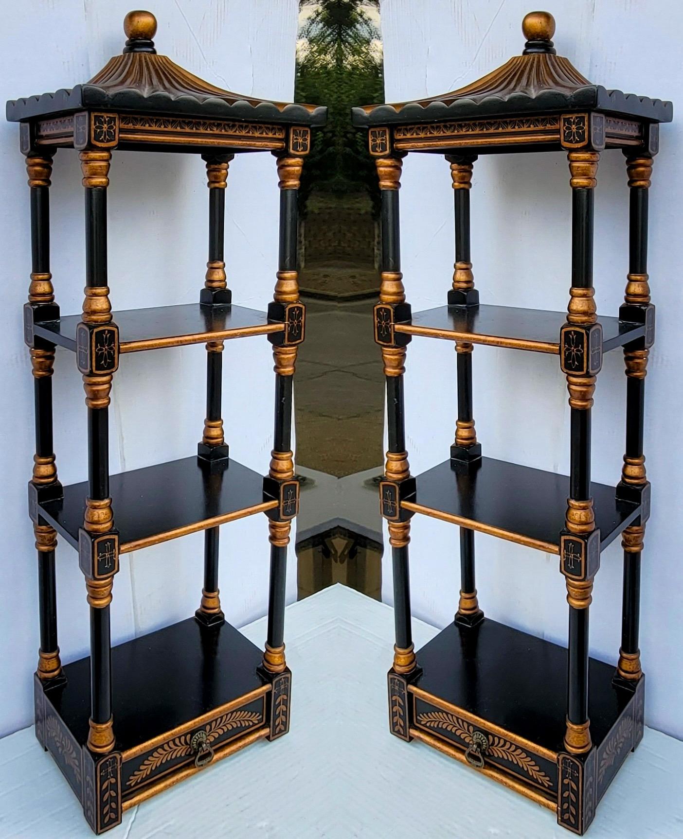 This is a late 20th century pair of chinoiserie pagoda form wall shelves. They have a single drawer and are black with gilt accents. Shelf depth is 7.75”. Heights from the bottom up are 10”, 8.75”, and 8.5”. 

 