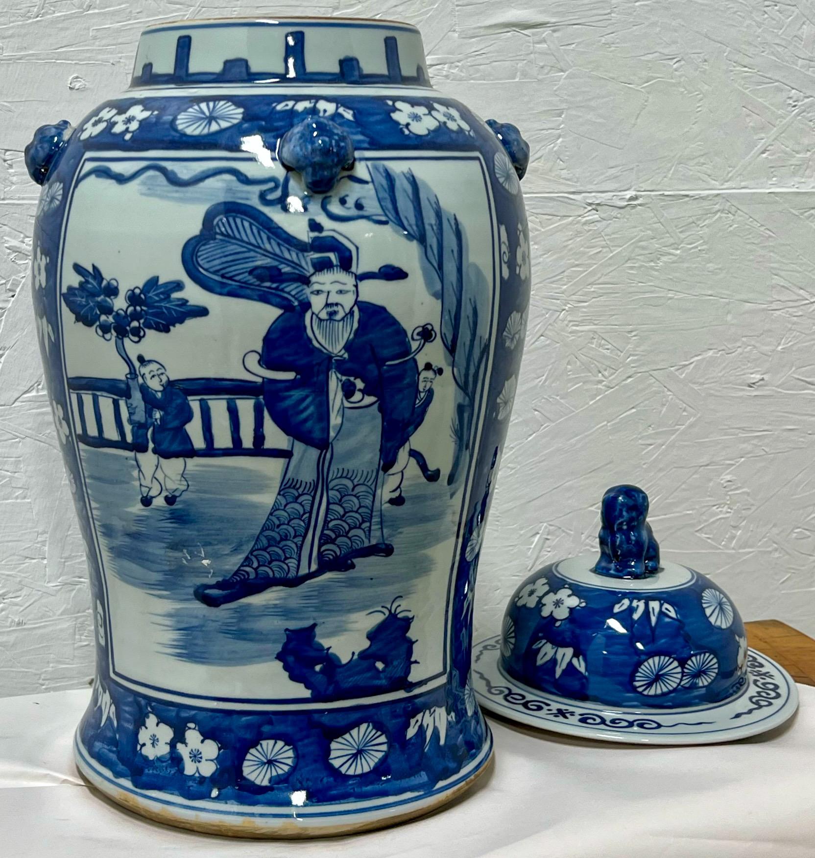 This is a late 20th century Chinese Export style Pair of blue and white ginger jars With foo dog finials and pastoral scenes. They are unmarked and in very good condition.