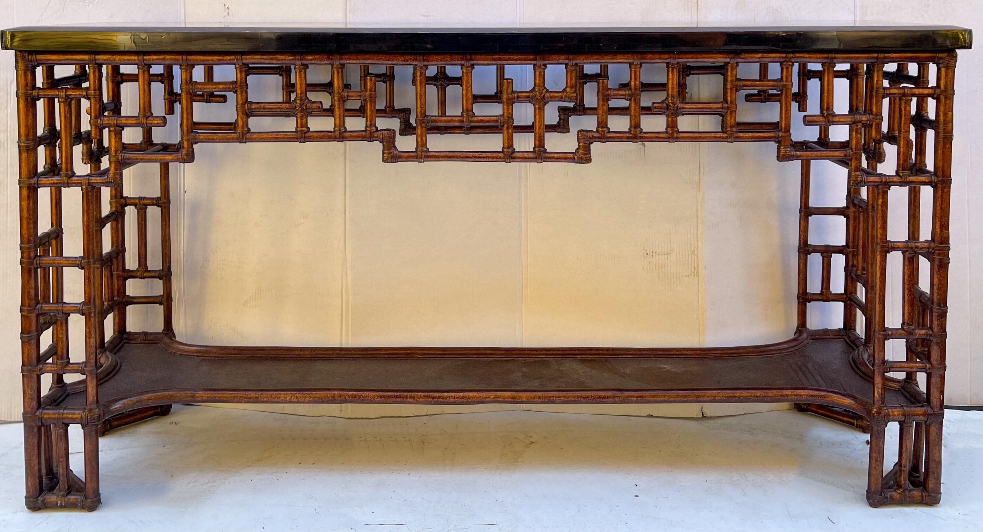This is an Asian inspired burnt bamboo and tessellated marble top console table. It has Chinese chippendale styling. It is in very good condition and marked on the underside.