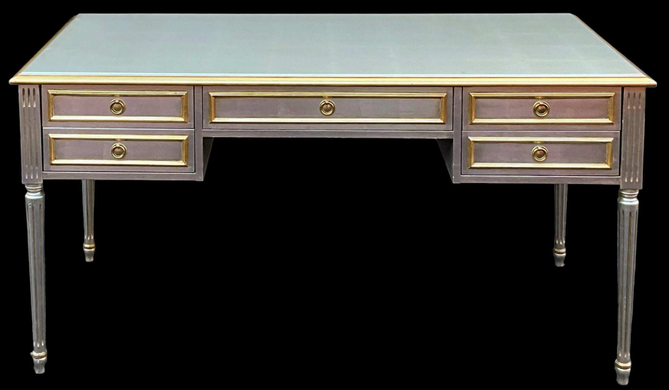 This is a show stopper! It is a French Louis XVI style writing desk that has been finished in the manner of Maison Jansen. It is unmarked and in very good condition. It dates most likely to the 1980s. Floor to apron is 25”. 