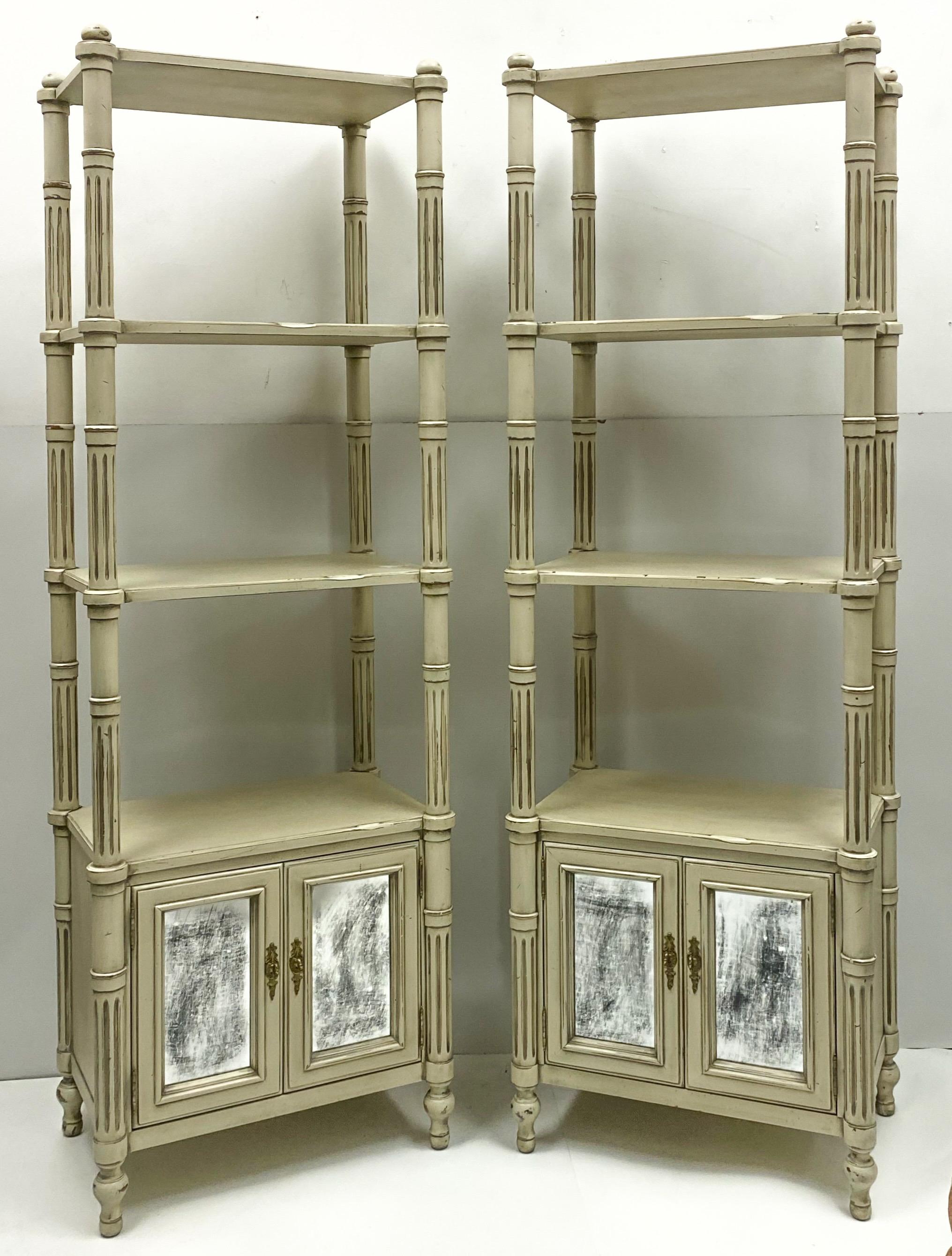 This is a pair of late 20th century Gustavian style etageres in very good condition. The doors have intentionally distressed mirror. They are unmarked.