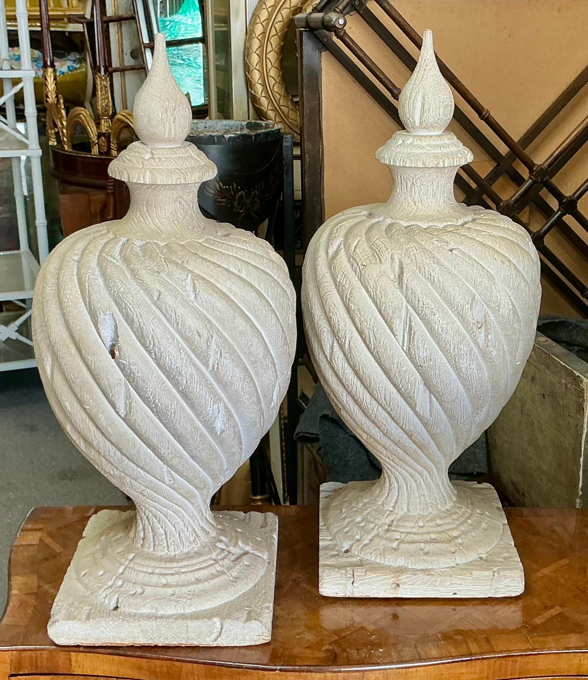 This is a large scale pair of neo-classical faux bois urns. They are a heavy casting which gives the look of a 19th century pair. They would look wonderful in a foyer or on a sideboard or even a garden setting. They are intentionally distressed and