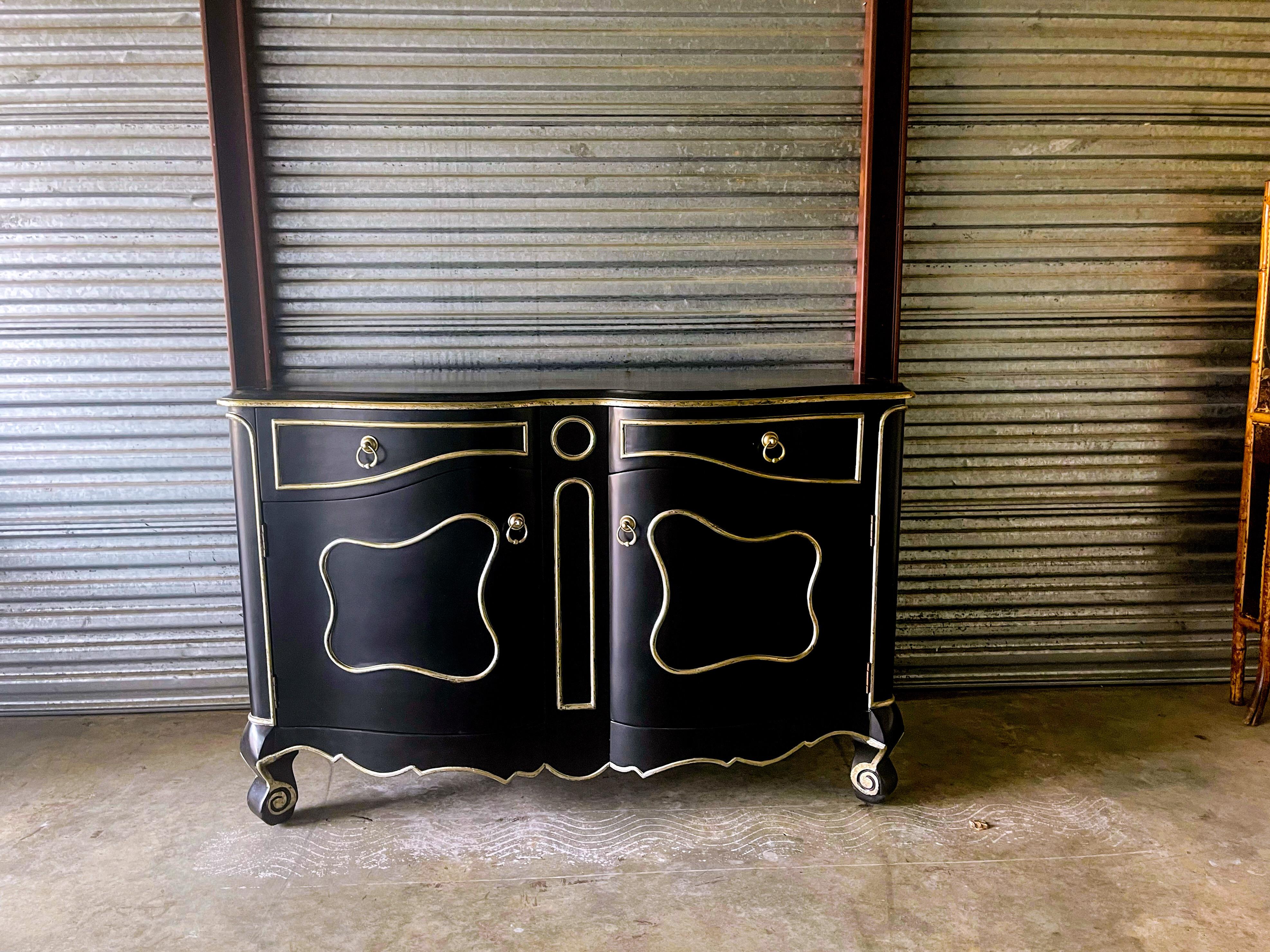These make a strong statement! These cabinets are unmarked but were purported to be a custom project for a client in New York. They are black with a silver gilt trim. Each cabinet is a modern interpretation of a Louis XV piece. They are in very good