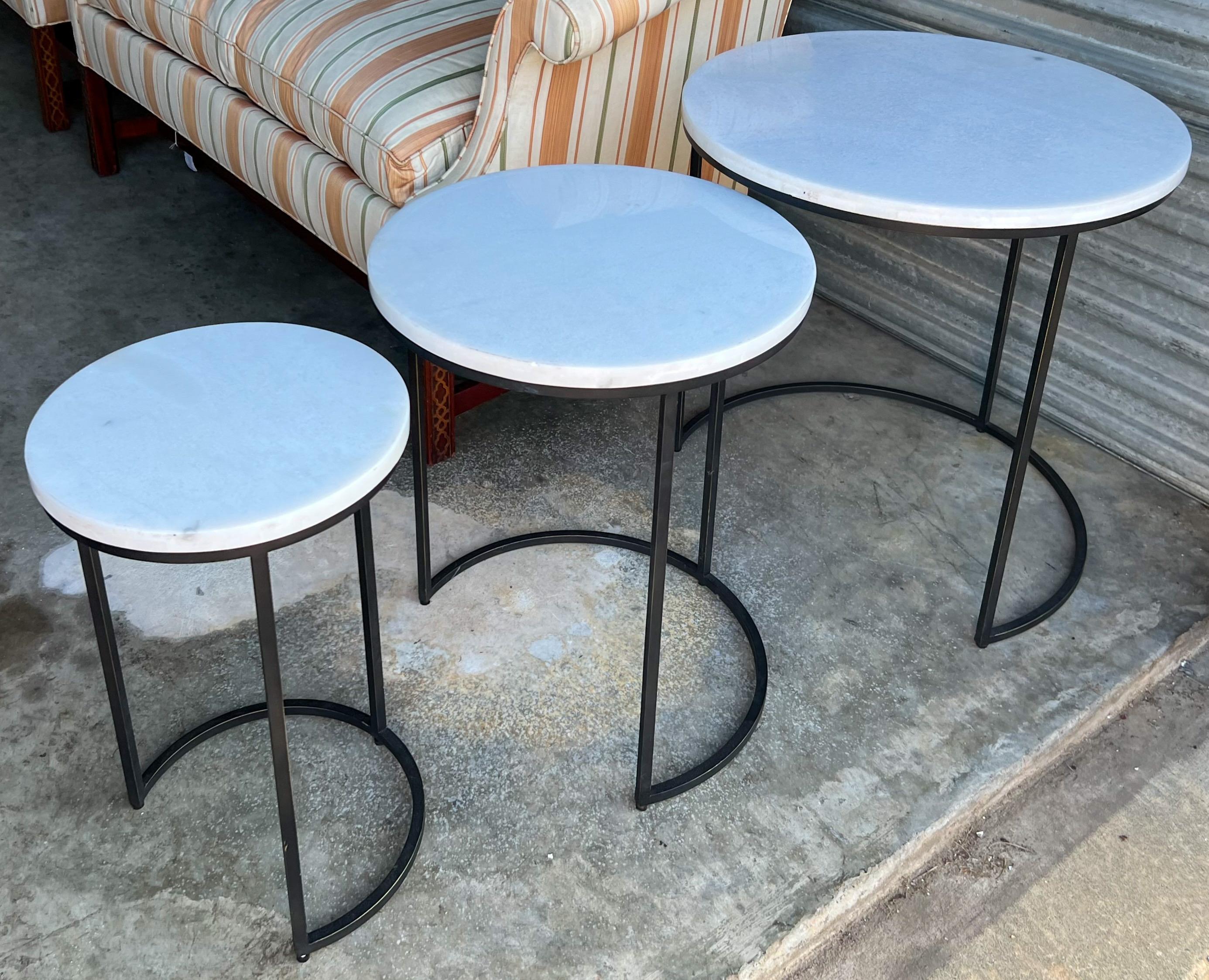 This is a late 20th century set of iron and marble set of nesting tables by Mitchell Gold and Bob Williams. The smallest is 12 inches in diameter and 19” high. They are in very good condition.