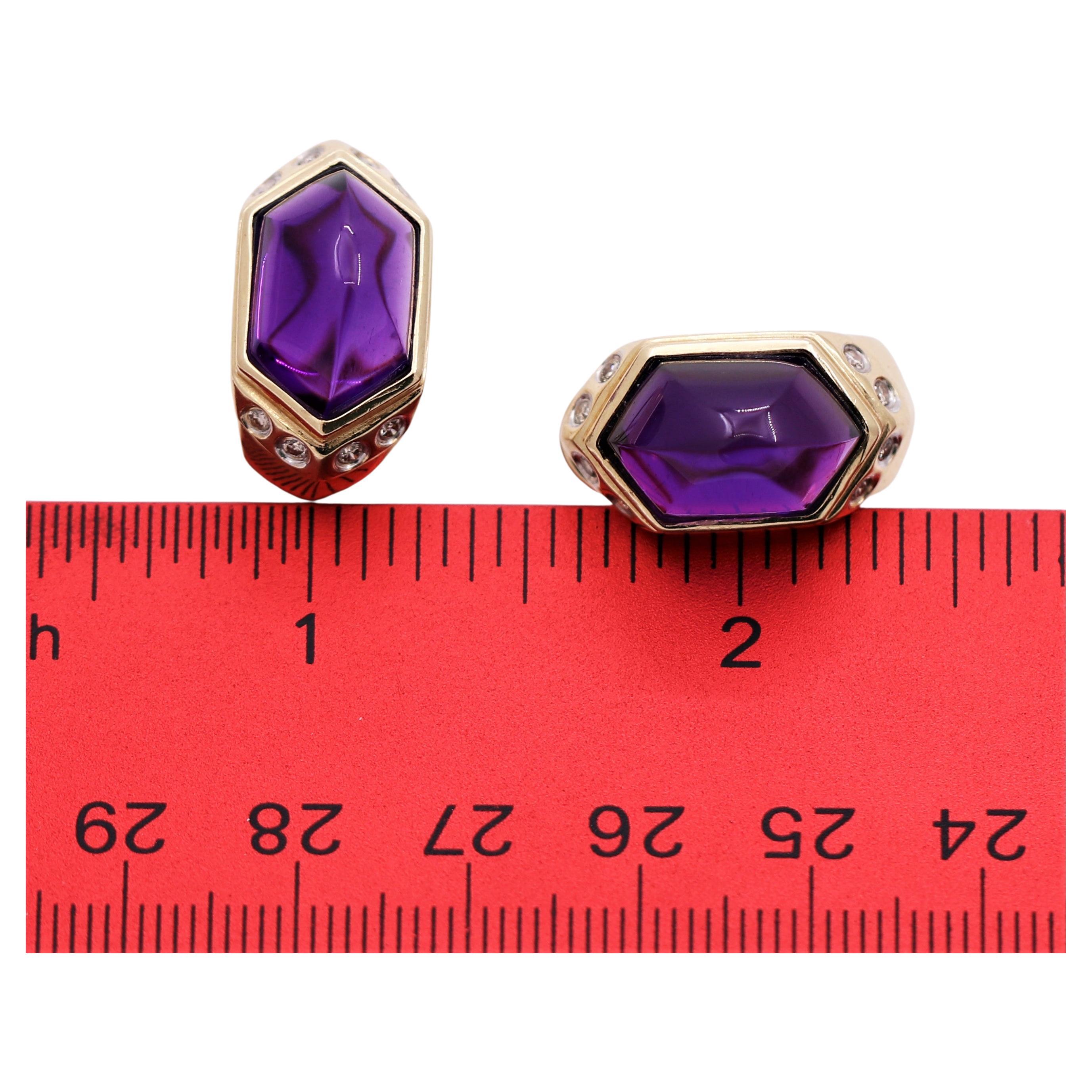 This lovely pair of Late-20th Century fashion earrings are crafted from 14k yellow gold and expertly bezel set with two large and luxurious amethysts, whose quality of color and clean internal characteristics can not be surpassed. Total approximate