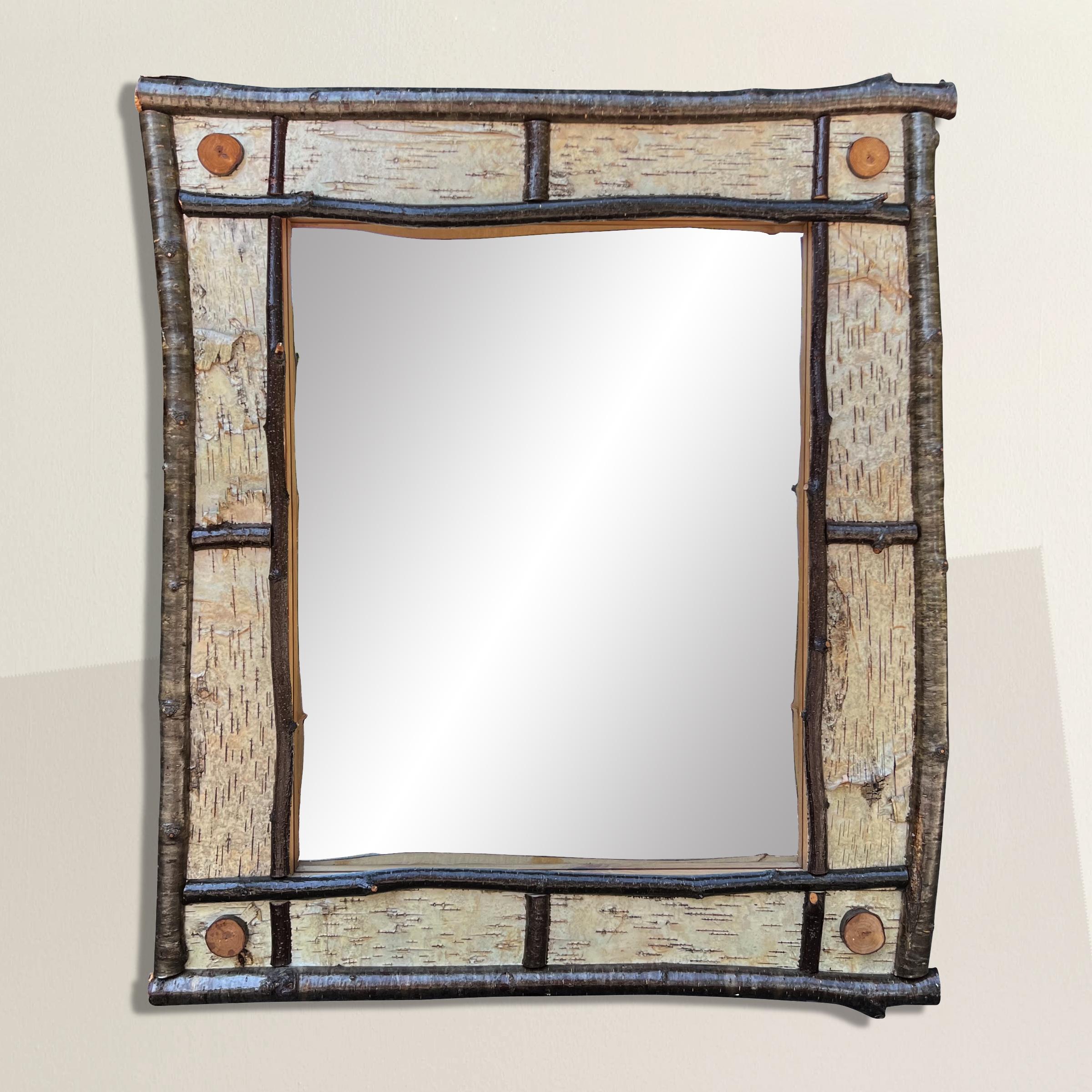 Step into a rustic reverie with this late 20th-century American Adirondack-style mirror, beautifully framed with birch bark and willow branches. Inspired by the iconic design aesthetic that emerged from the Adirondack Mountains in the 19th century,