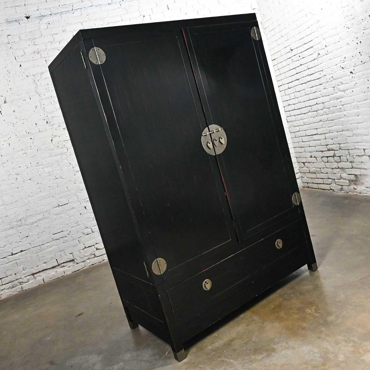 Handsome vintage chinoiserie Baker Milling road Line entertainment storage cabinet with black lacquered Asian style finish and pewter-like patinated steel hardware. Similar in style to Baker’s own mid-century Far East Collection by Michael Taylor.