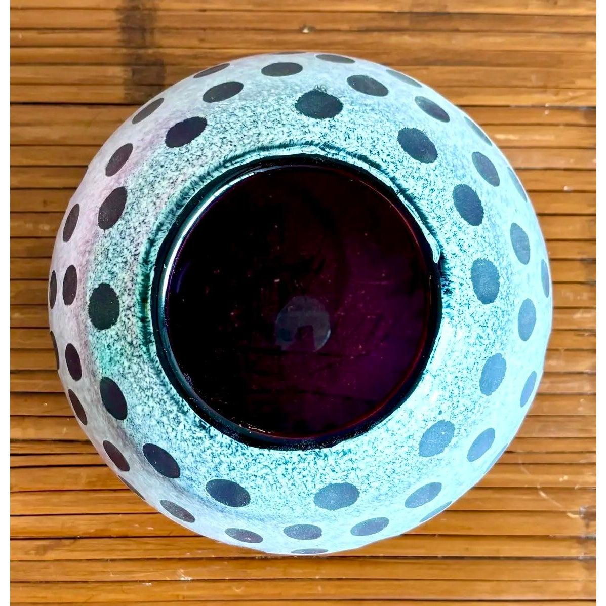 A bold and graphic hand-blown art glass vase featuring a frosted white surface layered over deep amethyst glass, carved away in a playful polka-dot and vertical stripe motif. The contrast between matte and gloss, round and linear, makes this a