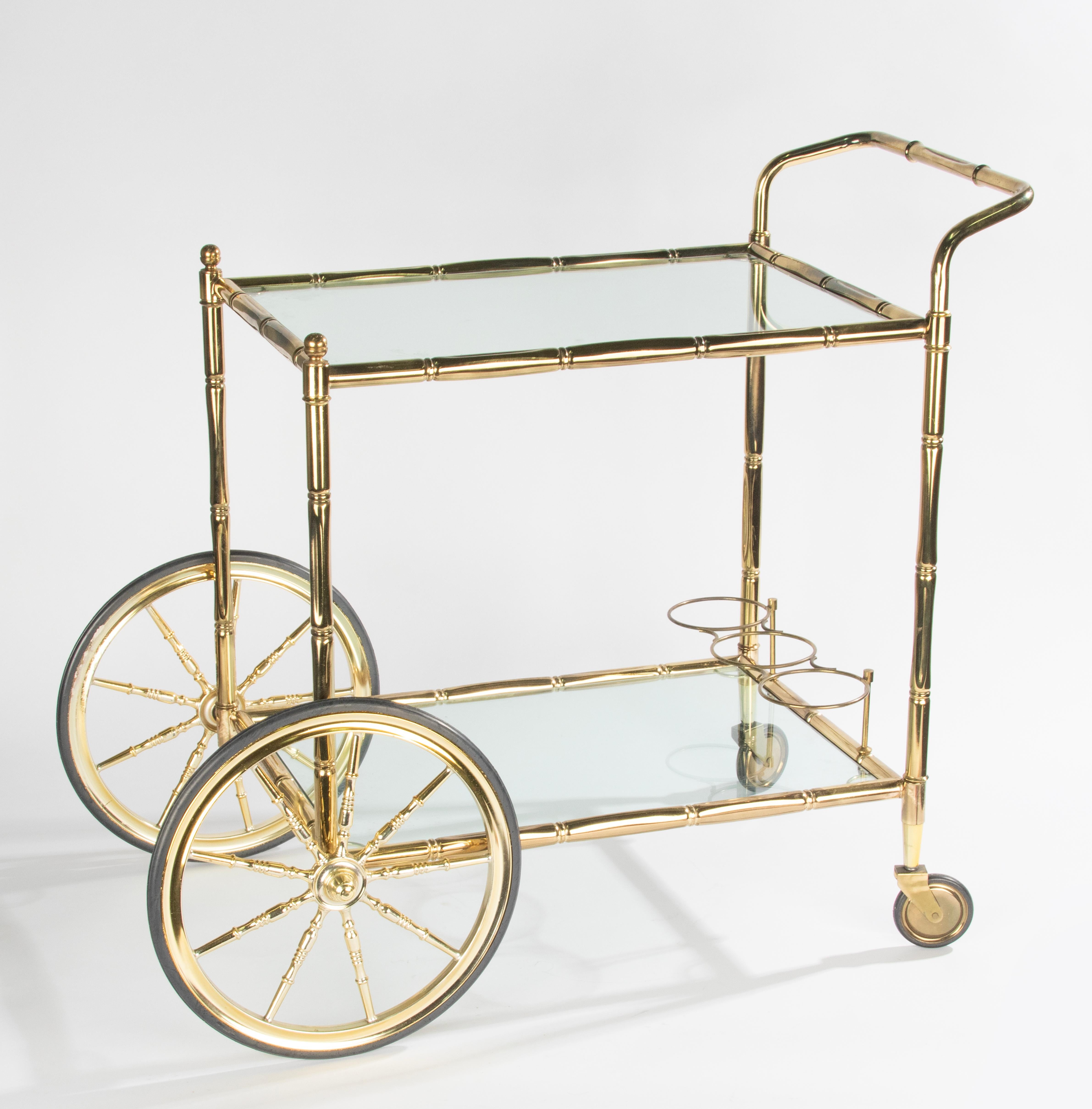 Elegant bar faux bamboo cart with two tiers with glass. The trolley is made of brass colored metal and glass, with beautiful details. Brass patina and glass are in good condition. Sturdy and rolling smoothly. Made in Belgium, 1970-1980
Dimensions: