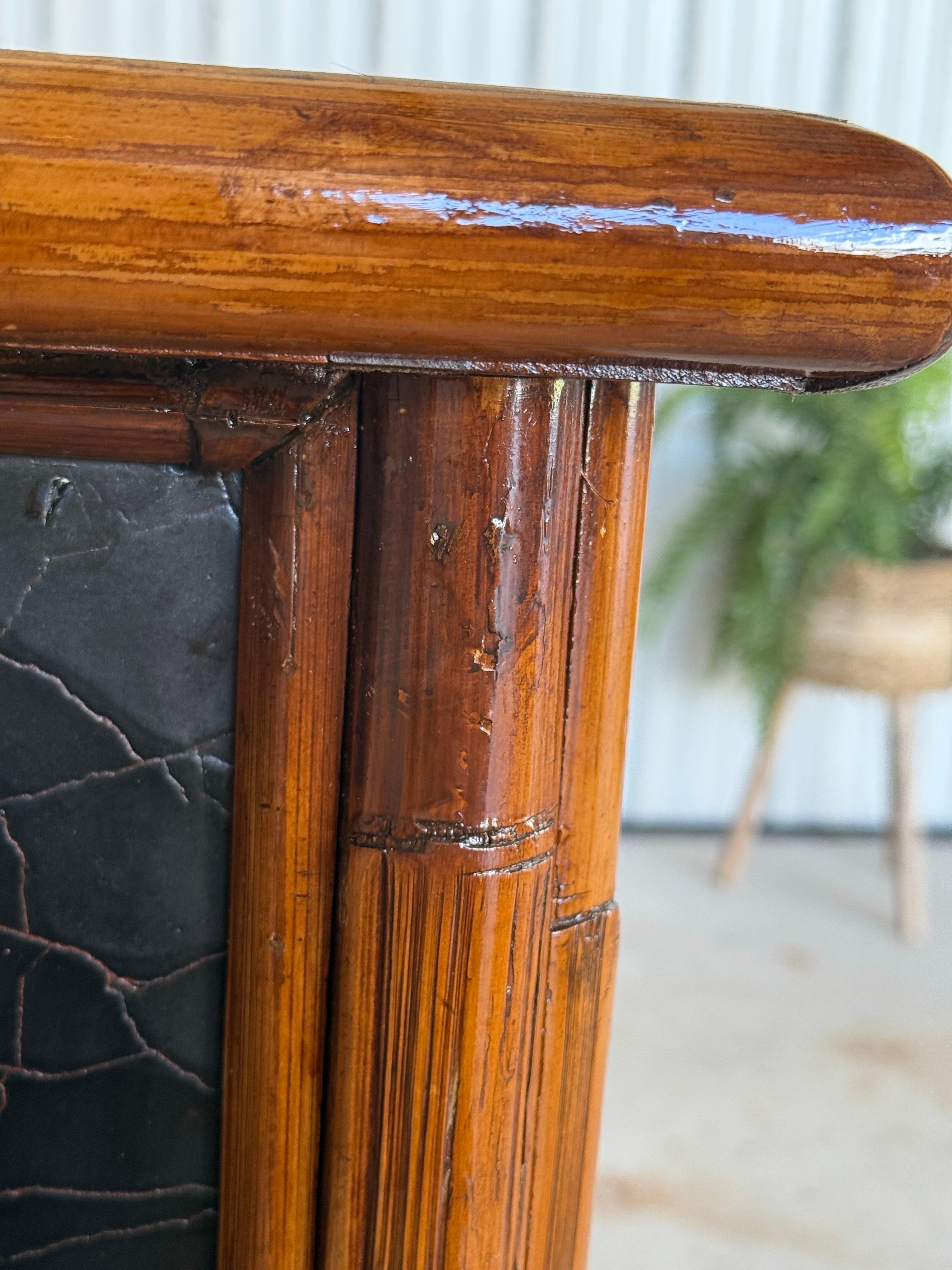 A refined example of British Colonial style, this late 20th century chest by Milling Road for Baker Furniture features a refinished rattan-wrapped drawer front design with a rich honey-toned frame, contrasted by black lacquered panels and a textured