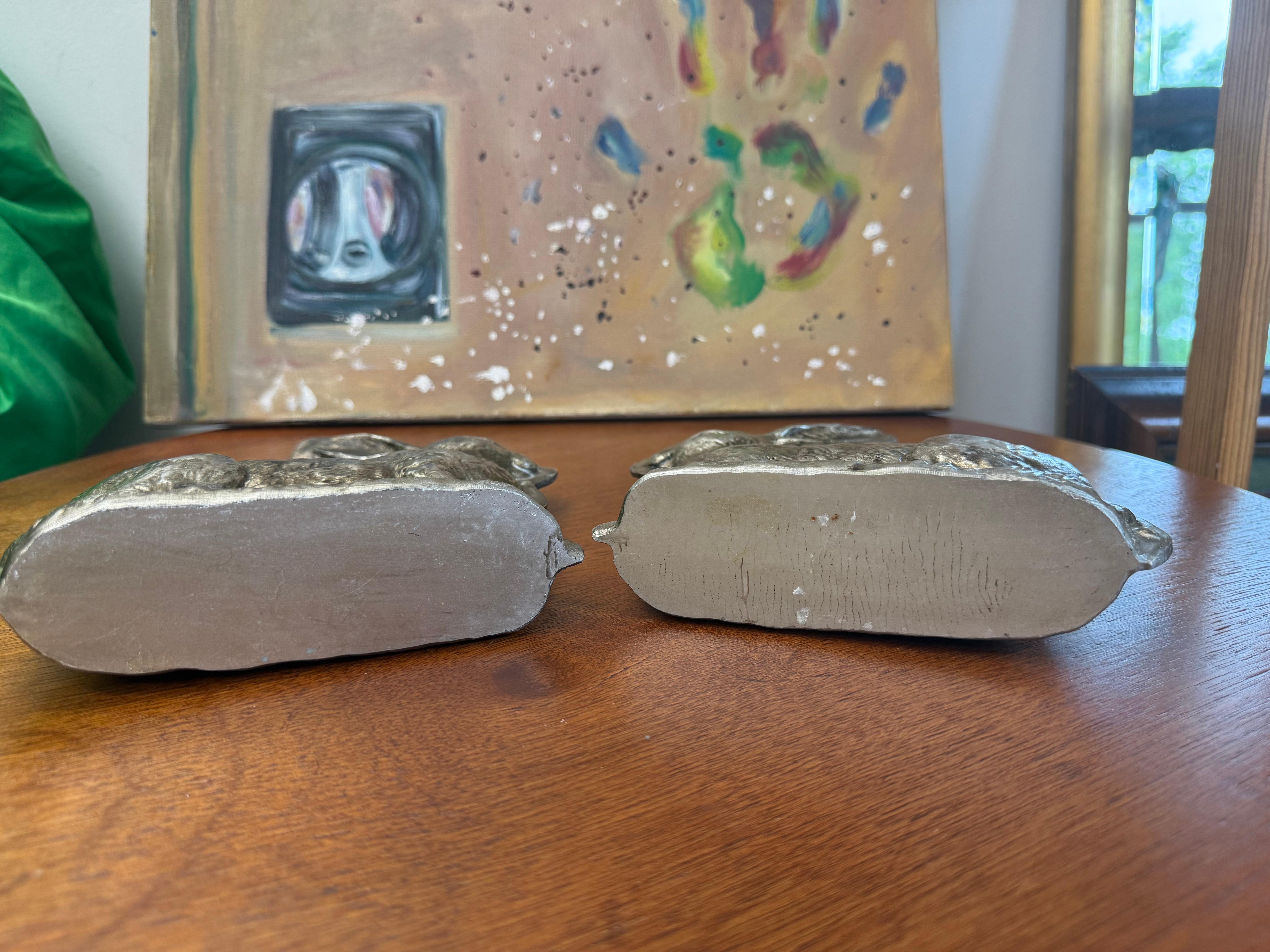 For your consideration we have a pair of decorative rabbit figures made of resin with an antiqued, silver-like finish. They are designed to look like vintage chocolate molds. These figures are often used as decorative items for shelves, mantles, or