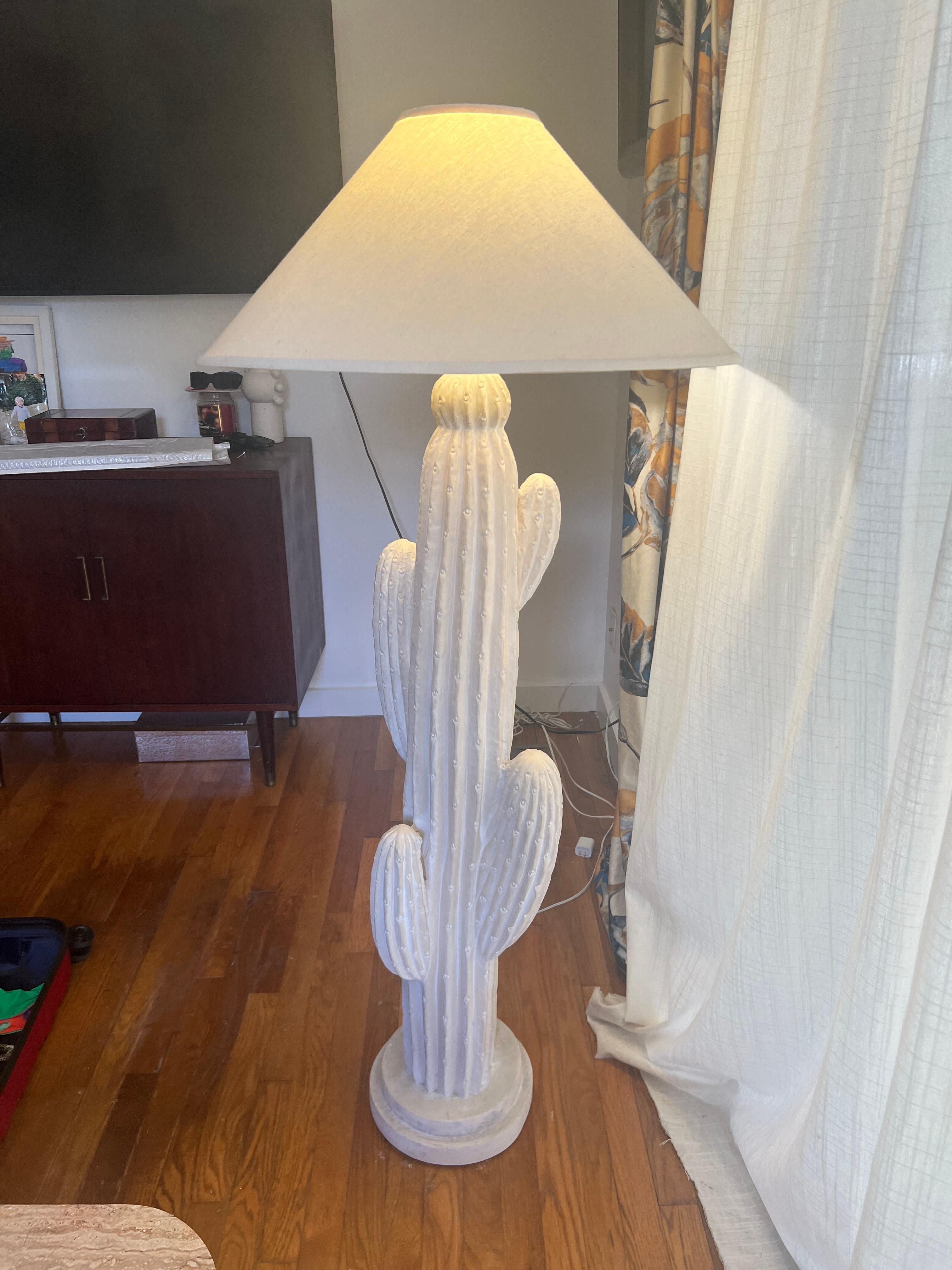 A funky plaster cream colored cactus lamp with a 3 way switch and a great shade!   

Terrific, folksy, painted plaster cactus sculpture floor lamp with pleasant soft green color. Original paint. Dated 1990 by Bon Art. 62