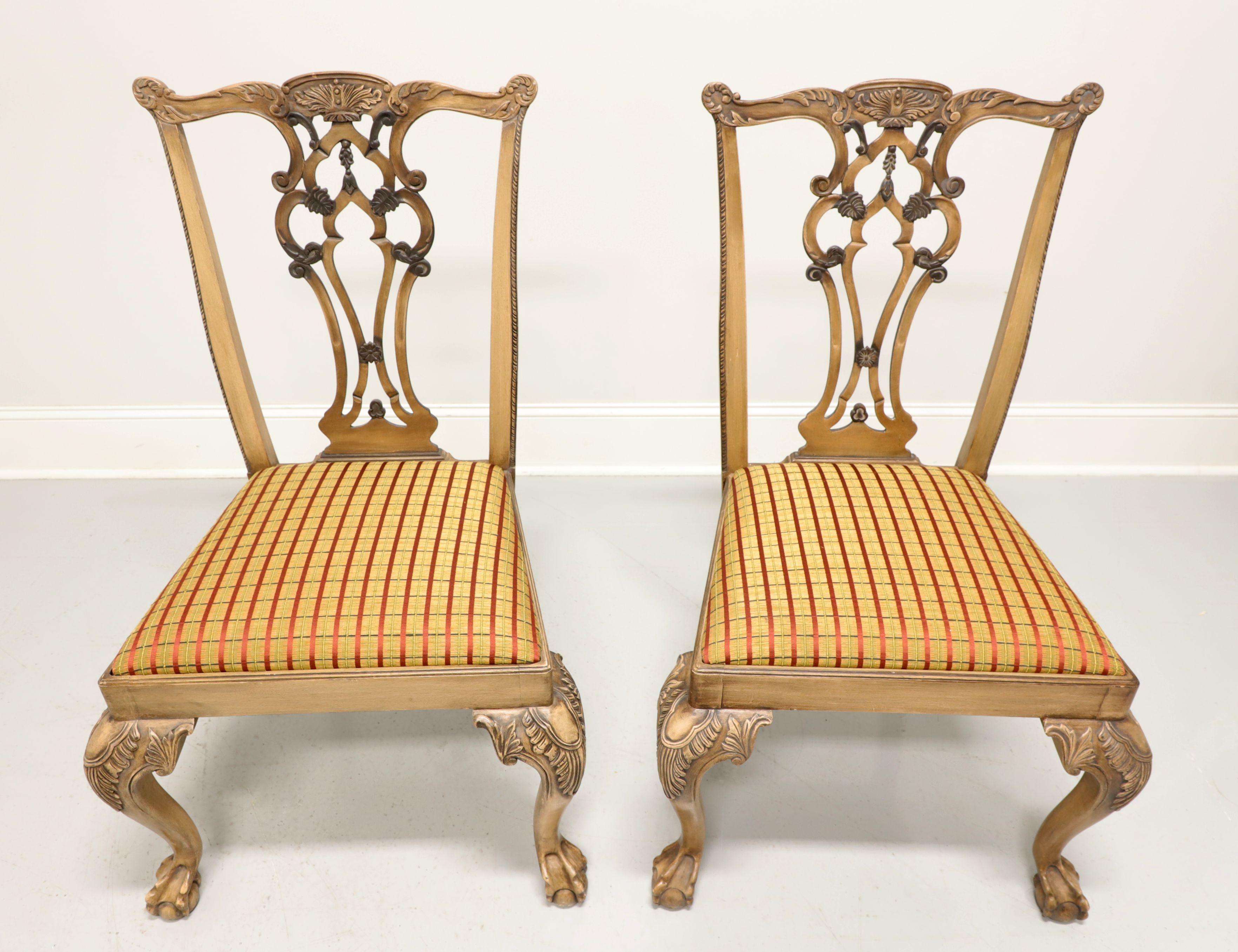 A pair of dining side chairs in the Chippendale style, unbranded, similar quality to Century or Hickory Chair. Solid hardwood with a slightly distressed light stain finish, carved crest rail, back splat, knees and cabriole legs with ball in claw