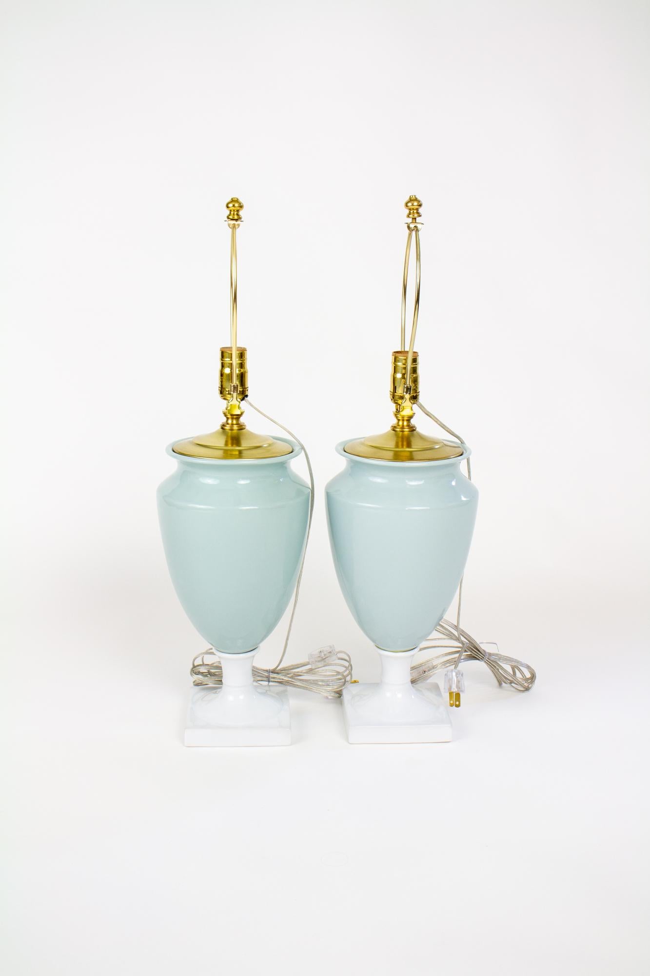Late 20th Century celadon and white porcelain urn table lamps, a pair. Classically shaped porcelain table lamps, celadon with a white porcelain stem and base. The porcelain is from the 1990’s and was non destructively turned into custom lamps in our