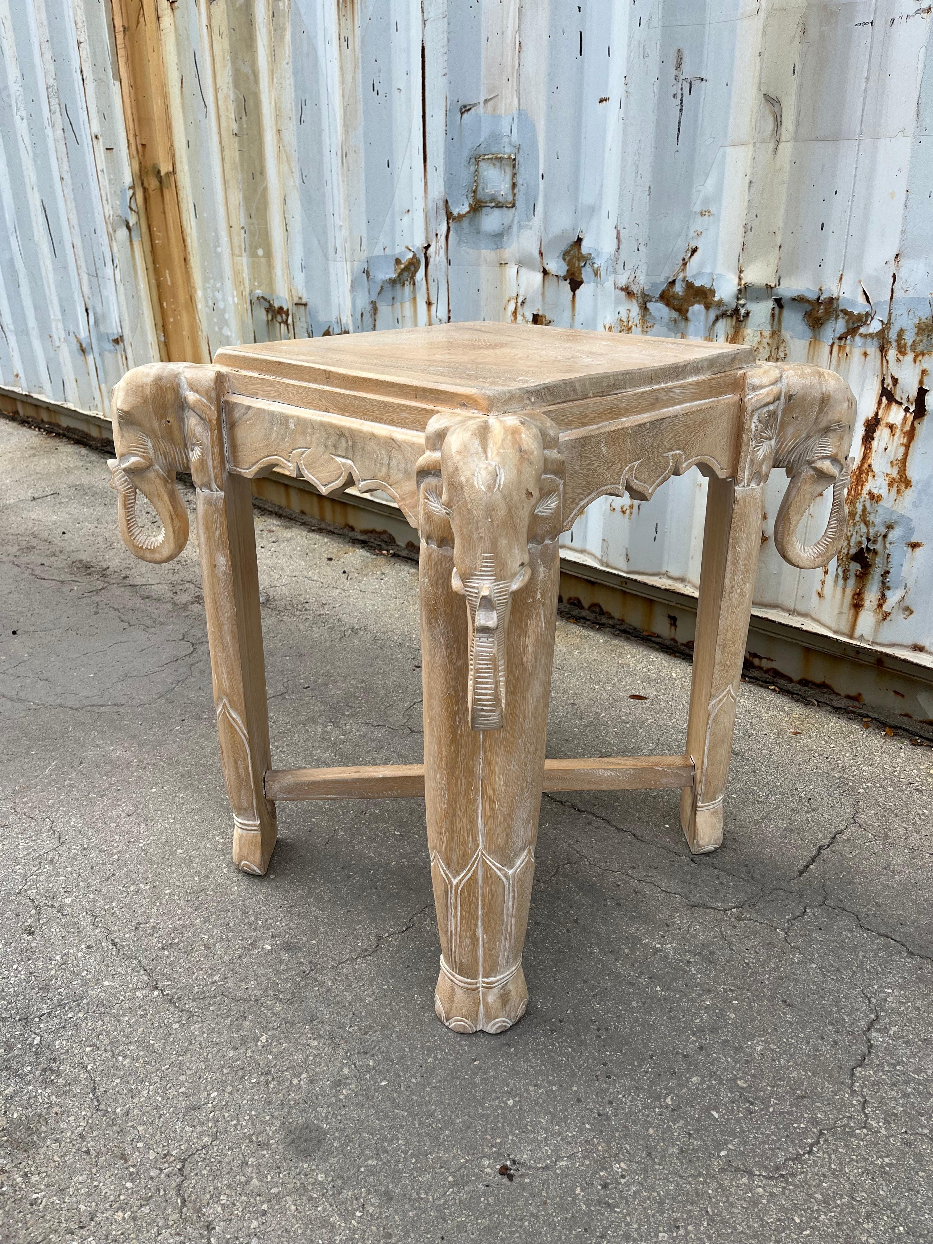 Late 20th Century Cerused Hand Carved Elephant Center / Accent Table.
Features a beautiful Bohemian/Coastal Style, four hand-carved elephant heads at corners, and a cerused finish that emphasizes the wood grain.
In Good Original Condition with minor
