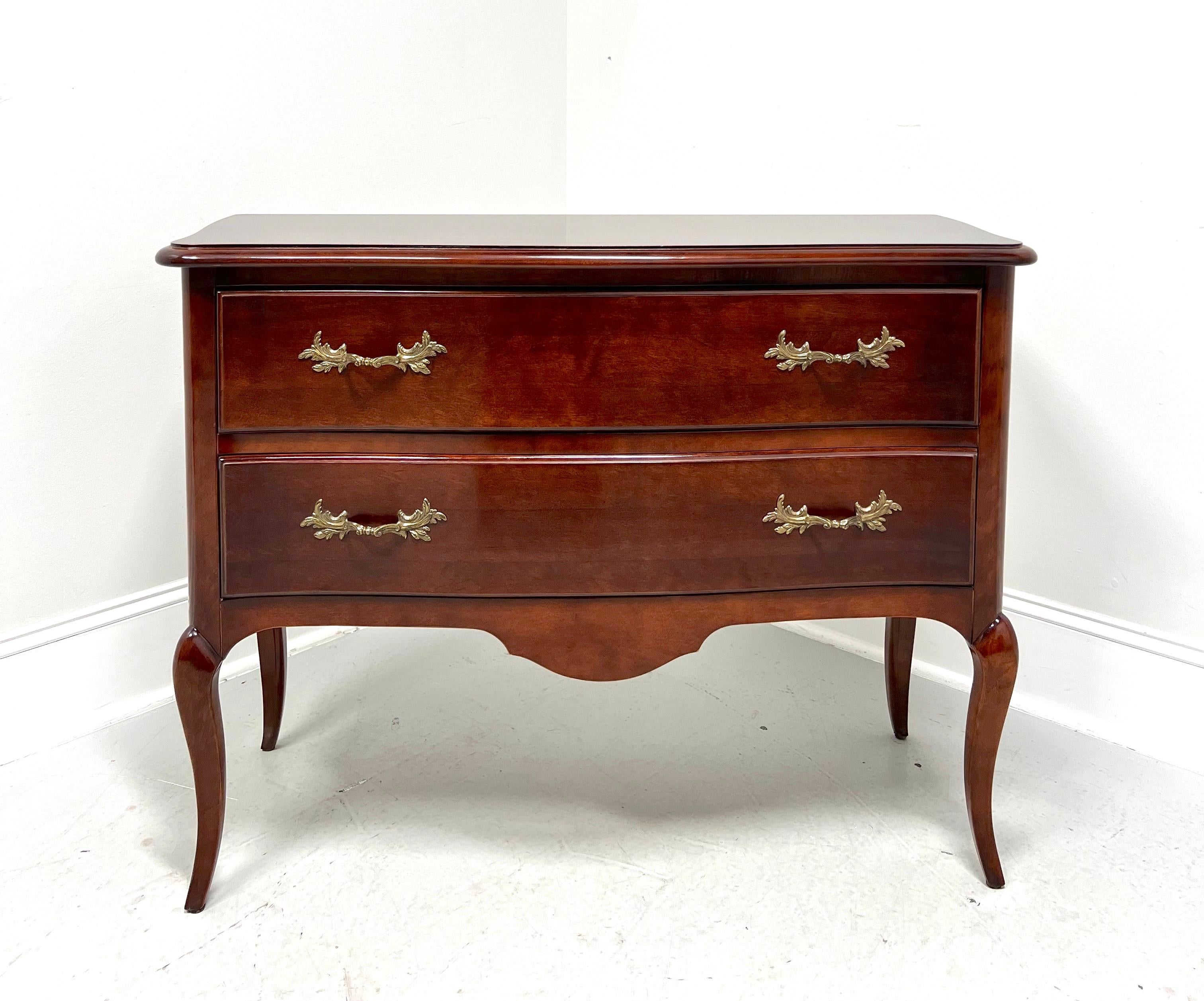 A French Provincial Louis XV style occasional chest, unbranded, similar quality to Century Furniture or Henredon. Cherry wood with brass hardware, ogee edge to the top, carved apron, and curved legs. Features two drawers of dovetail construction.