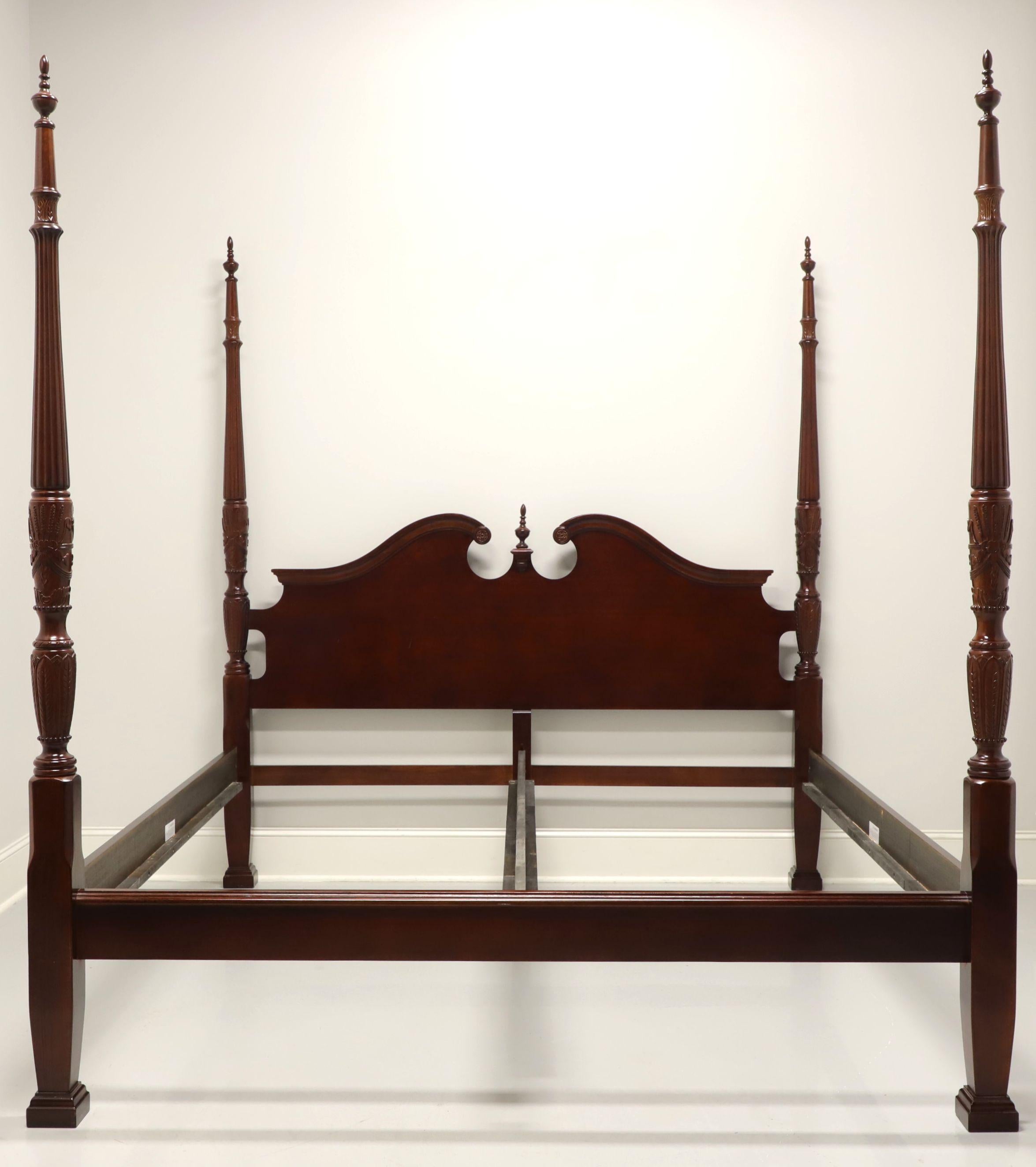 A Traditional style king size poster bed by Universal Furniture. Cherry wood with four rice carved posts with finials, brass hardware accents, clip held side & center rails with screw affixed wood strips providing mattress support. Headboard