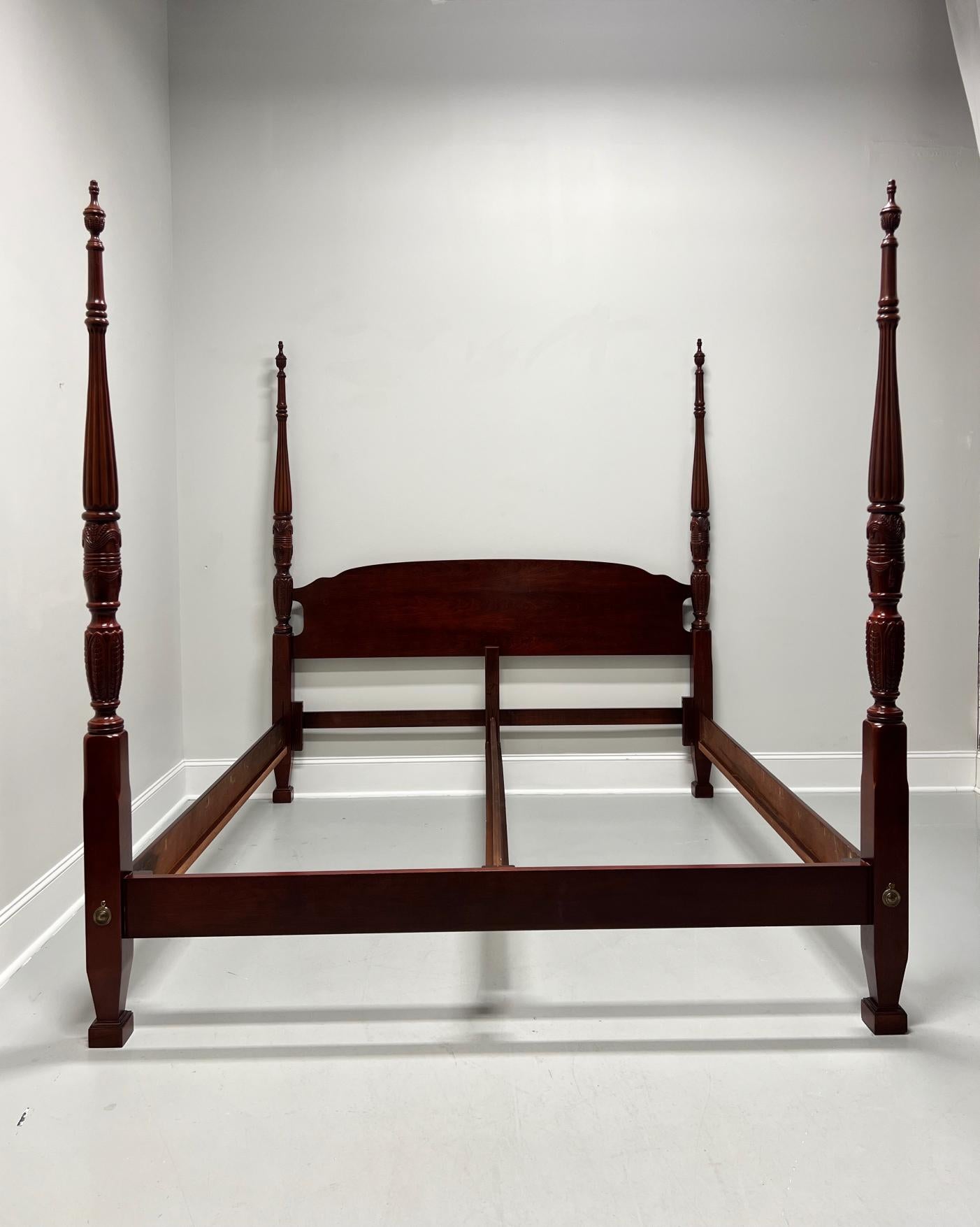 A Chippendale style king size four poster bed, unbranded, similar in quality to Lexington or Thomasville. Cherry wood with carved arch headboard, four tobacco leaf carved posts capped by finials, clip held side & center rails with affixed wooden