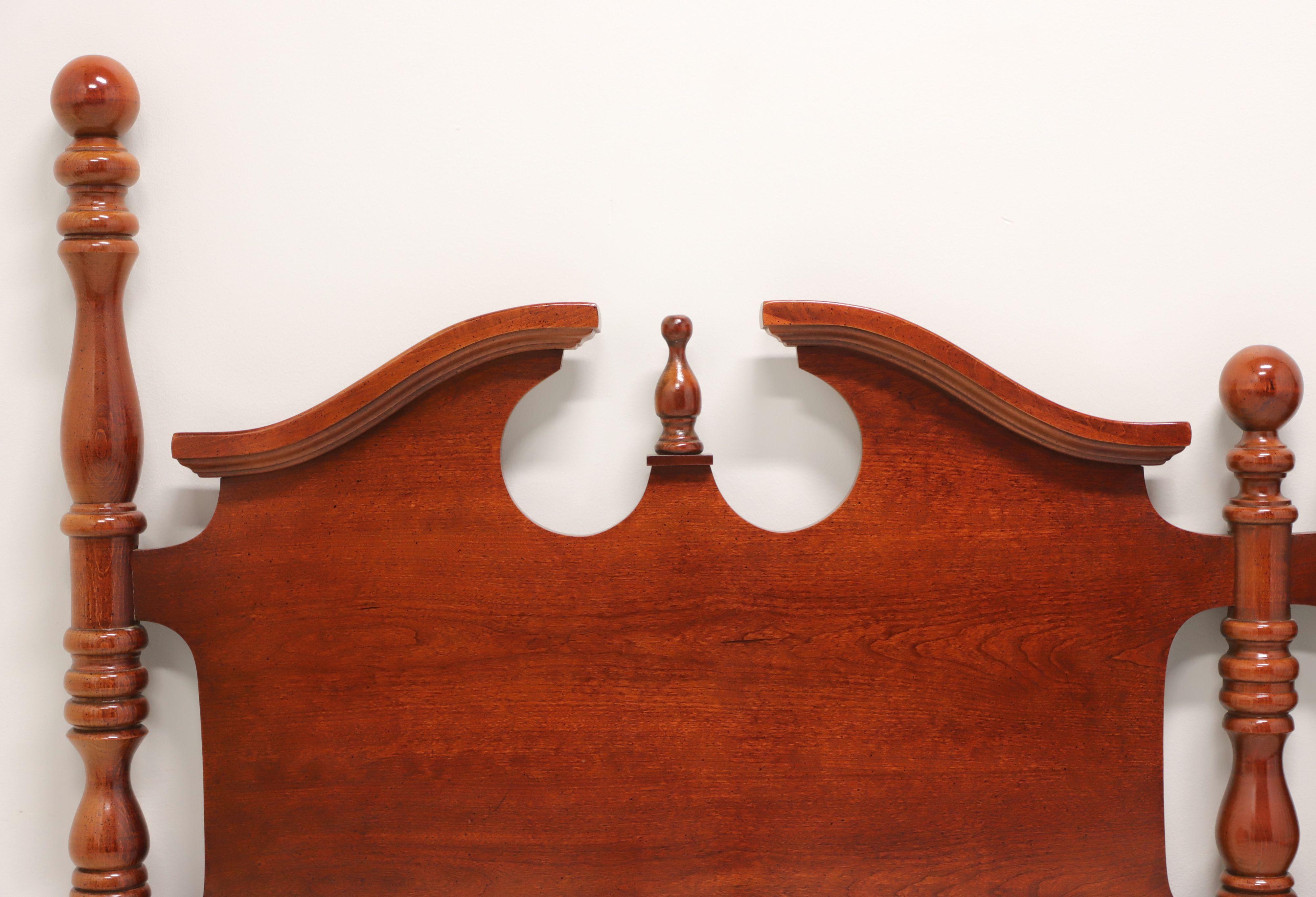A Traditional Georgian style king Size short poster headboard by Thomasville. Solid cherry, double pediments with center finials, three turned posts capped with round ball like finials, and square lower posts. Made in North Carolina, USA, in the