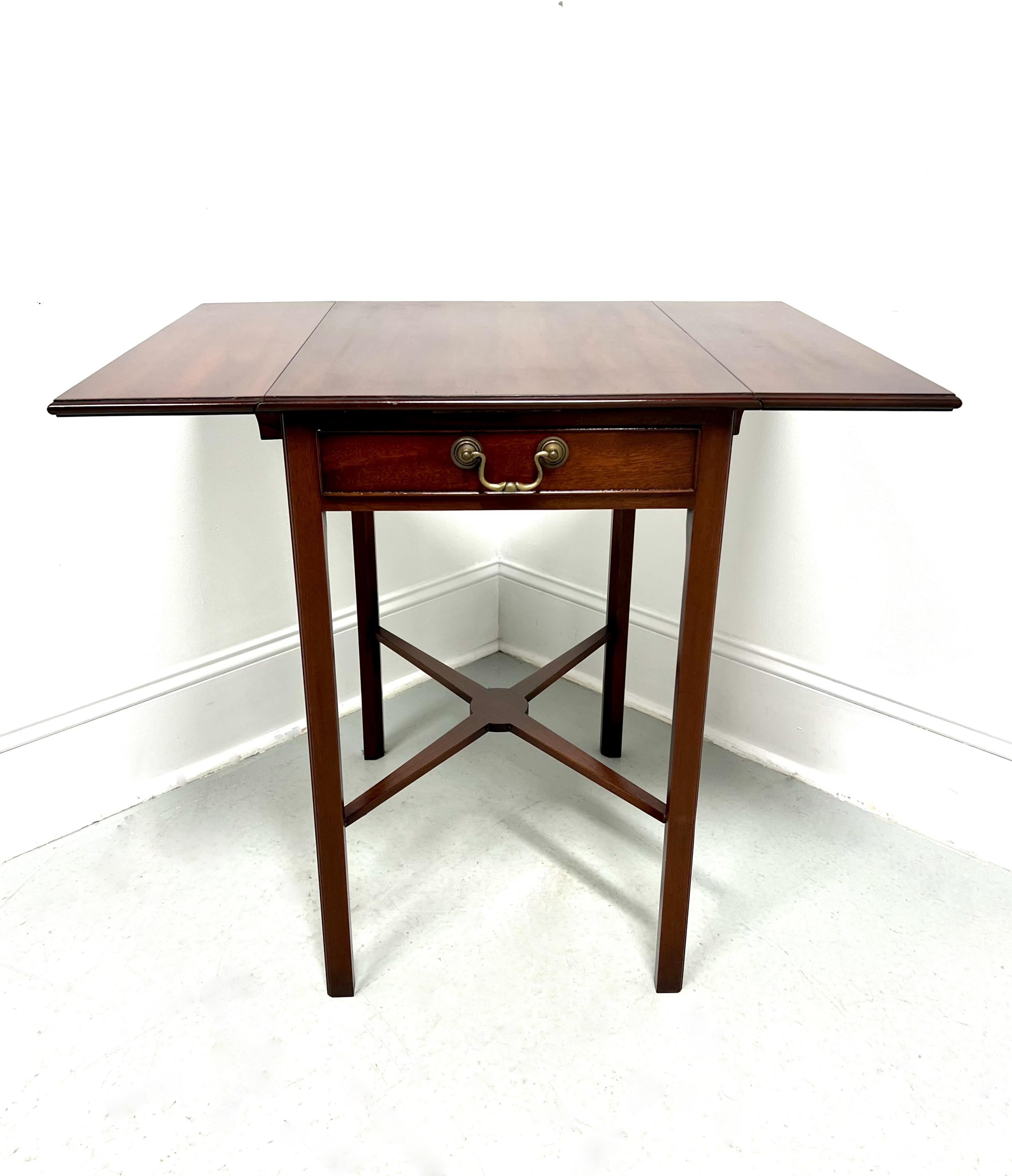 A Chippendale style drop-leaf side table, unbranded. Made for high end furniture dealer, Colony Furniture of Charlotte, North Carolina, USA, under their private label. Likely made for them by Hickory Chair or similar. Mahogany with brass hardware,