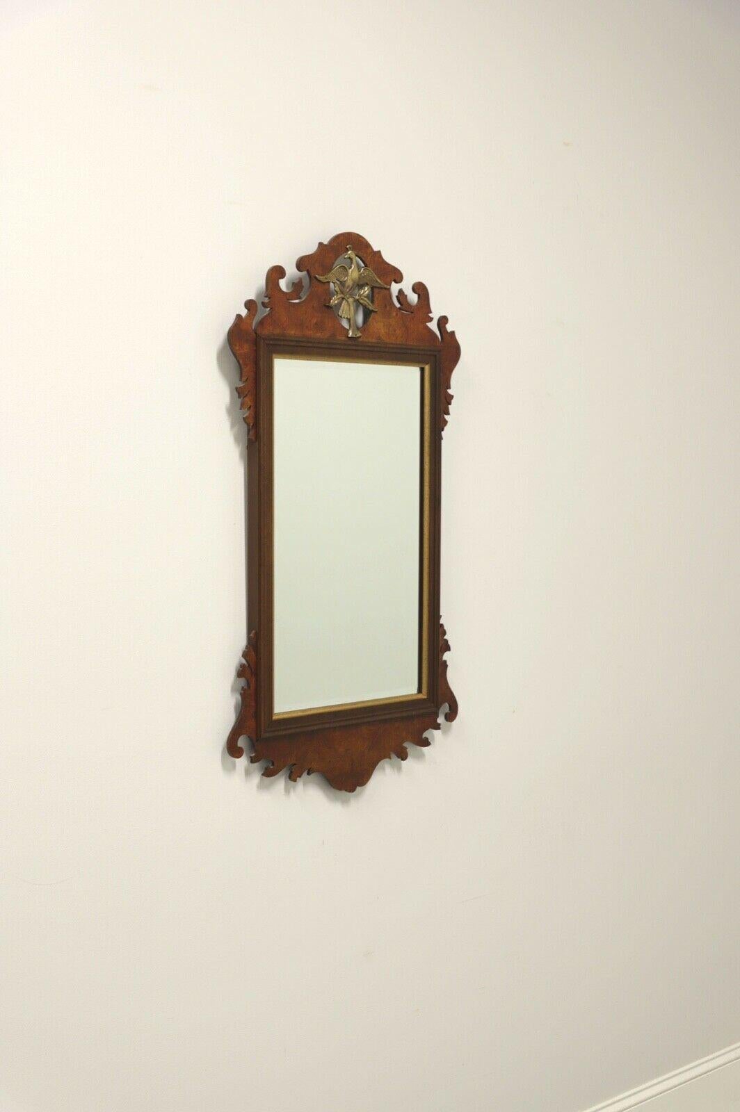 A Chippendale style wall mirror, unbranded, similar quality to quality to Drexel or Henkel Harris. Mirror glass, burl walnut frame with decorative carvings and brass bird in a tree branch to top. Made in the USA, in the late 20th century.

Measures: