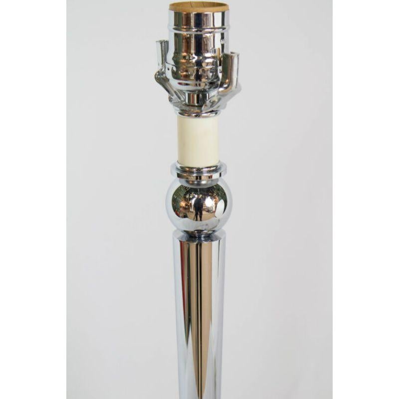 Late 20th Century Chrome Table Lamp. Flat round Base, stem tapers from top to bottom.  topped with a ball and faux candle.  Includes harp.  Switch on cord

Material: Chrome
Style: Contemporary
Place of Origin: United States of America
Period made: