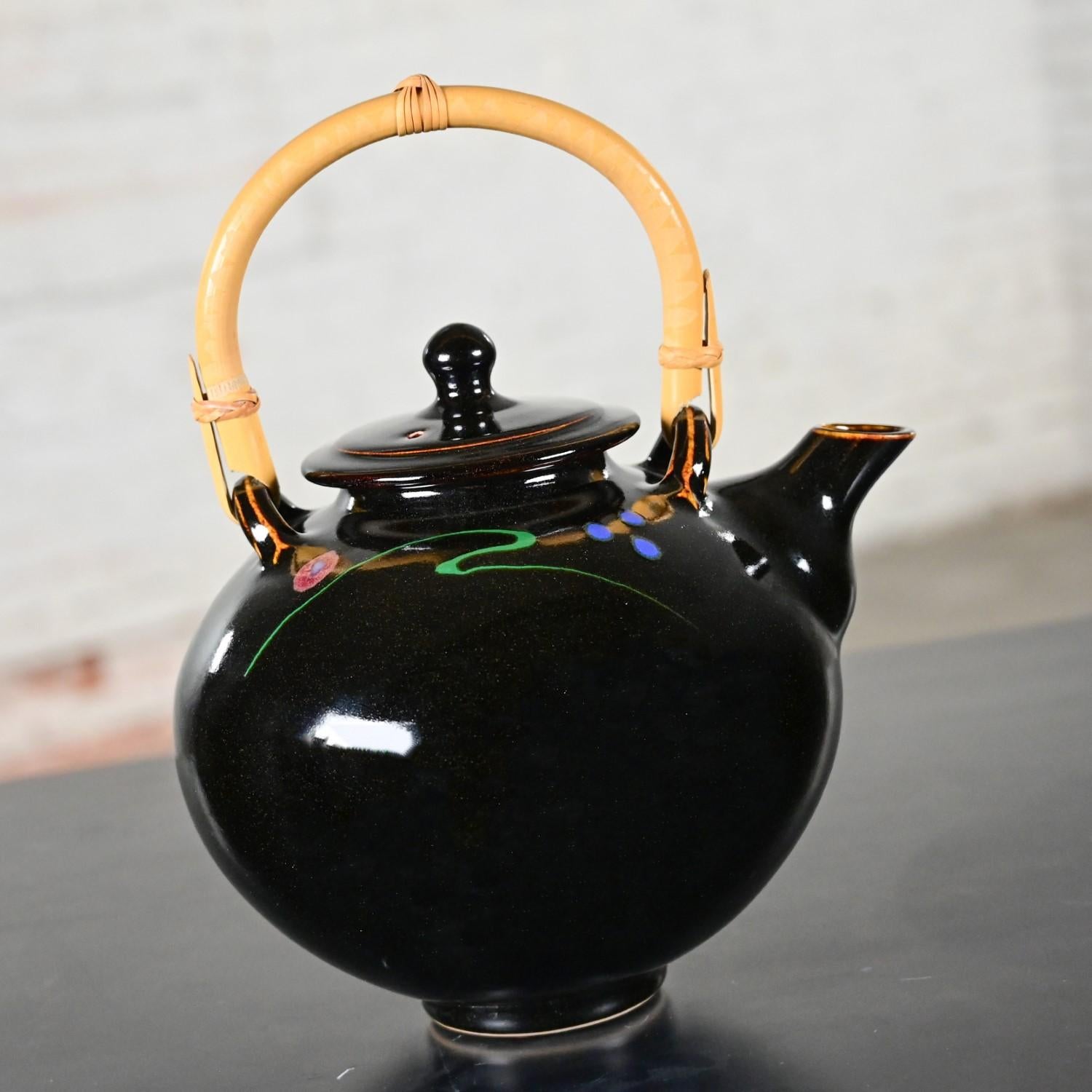 Magnificent vintage Contemporary Asian dark chocolate brown glazed ceramic teapot with wrapped natural rattan handle. Beautiful condition, keeping in mind that this is vintage and not new so will have signs of use and wear even if it has been