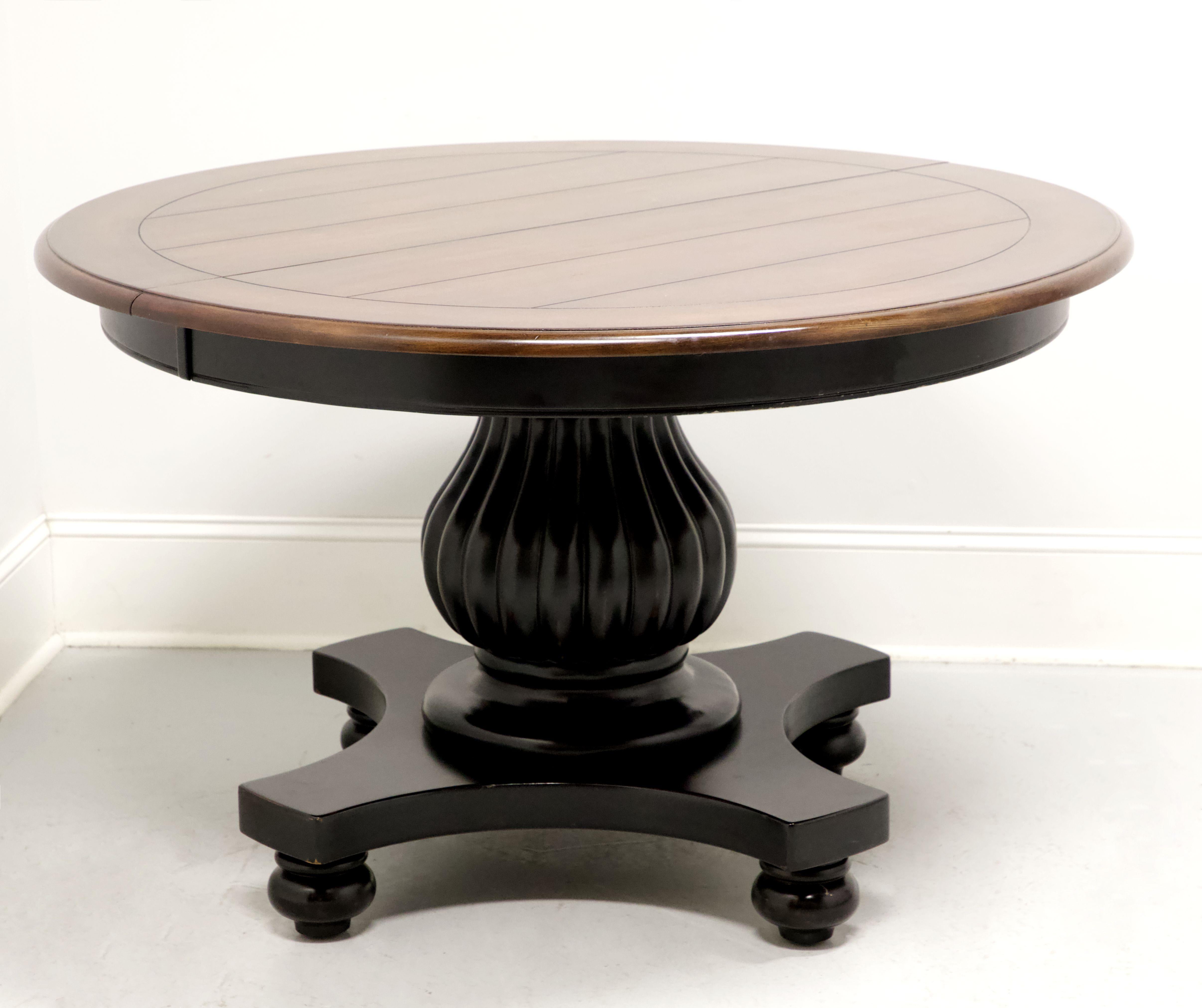 A Cottage / Farmhouse style round pedestal dining table, unbranded. Hardwood with a distressed black painted finish, natural cherry plank style banded top, smooth apron, wide round fluted pedestal base with 