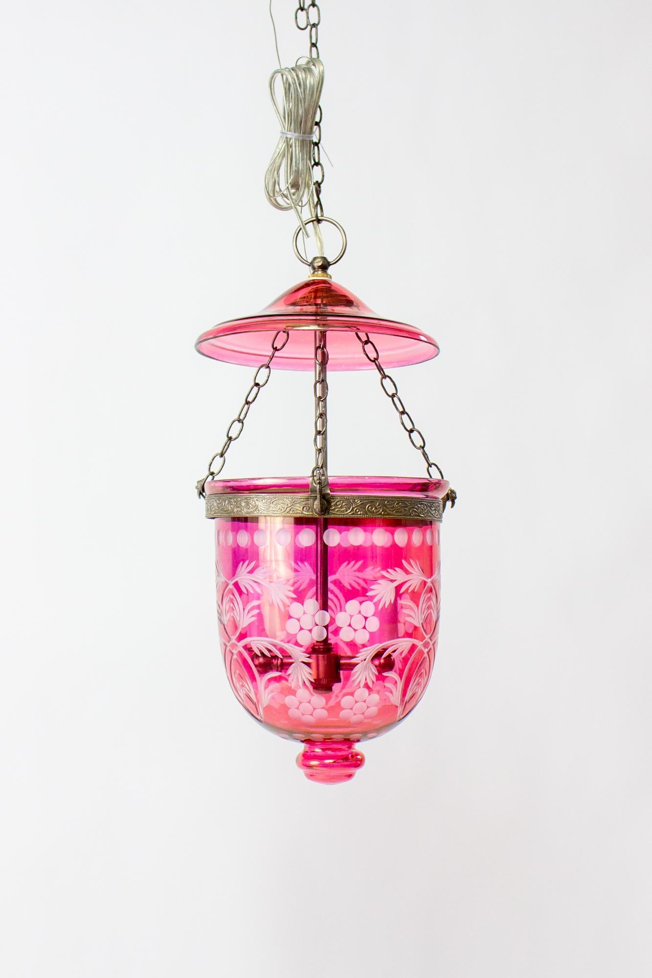 Cranberry bell jar lantern, late 20th century, made in India. 
 Bell jar lanterns first reached popularity in colonial India and due to their lingering popularity, production has continued to the present. This piece is made from delicately blown