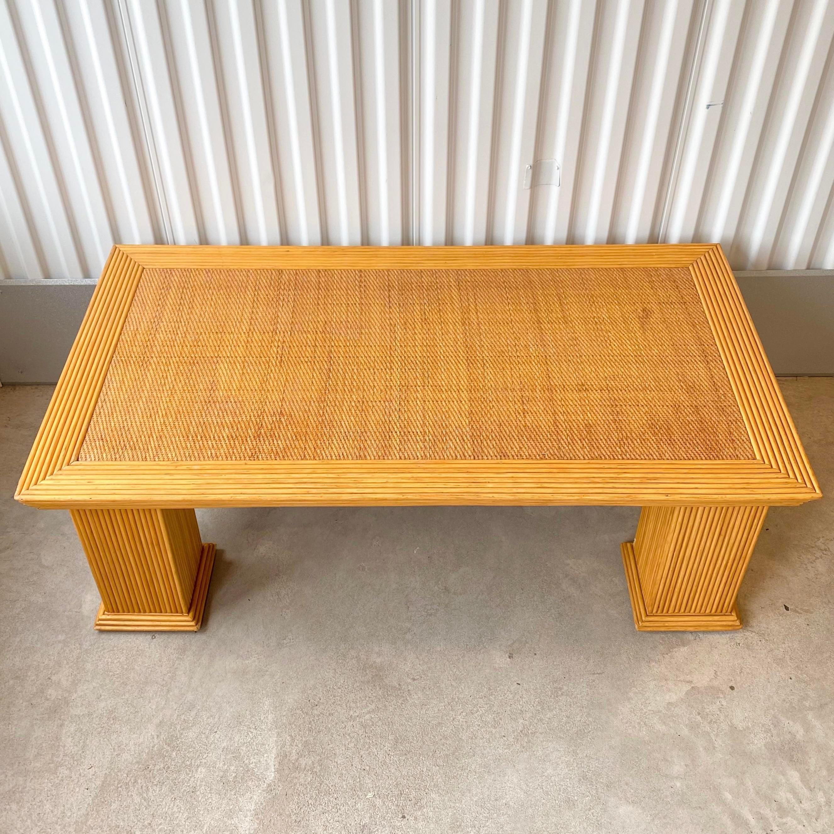 Vintage circa late 20th century (1979-1989) pencil reed and wicker coffee table.
Monumental column legs wrapped in pencil reed bamboo with inlay of wicker on the top surface to add texture to the sculptural design. In the style of Gabriella Crespi