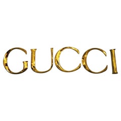 Late 20th Century Decorative Wall Ornament Gucci Letters Made in Golden Brass