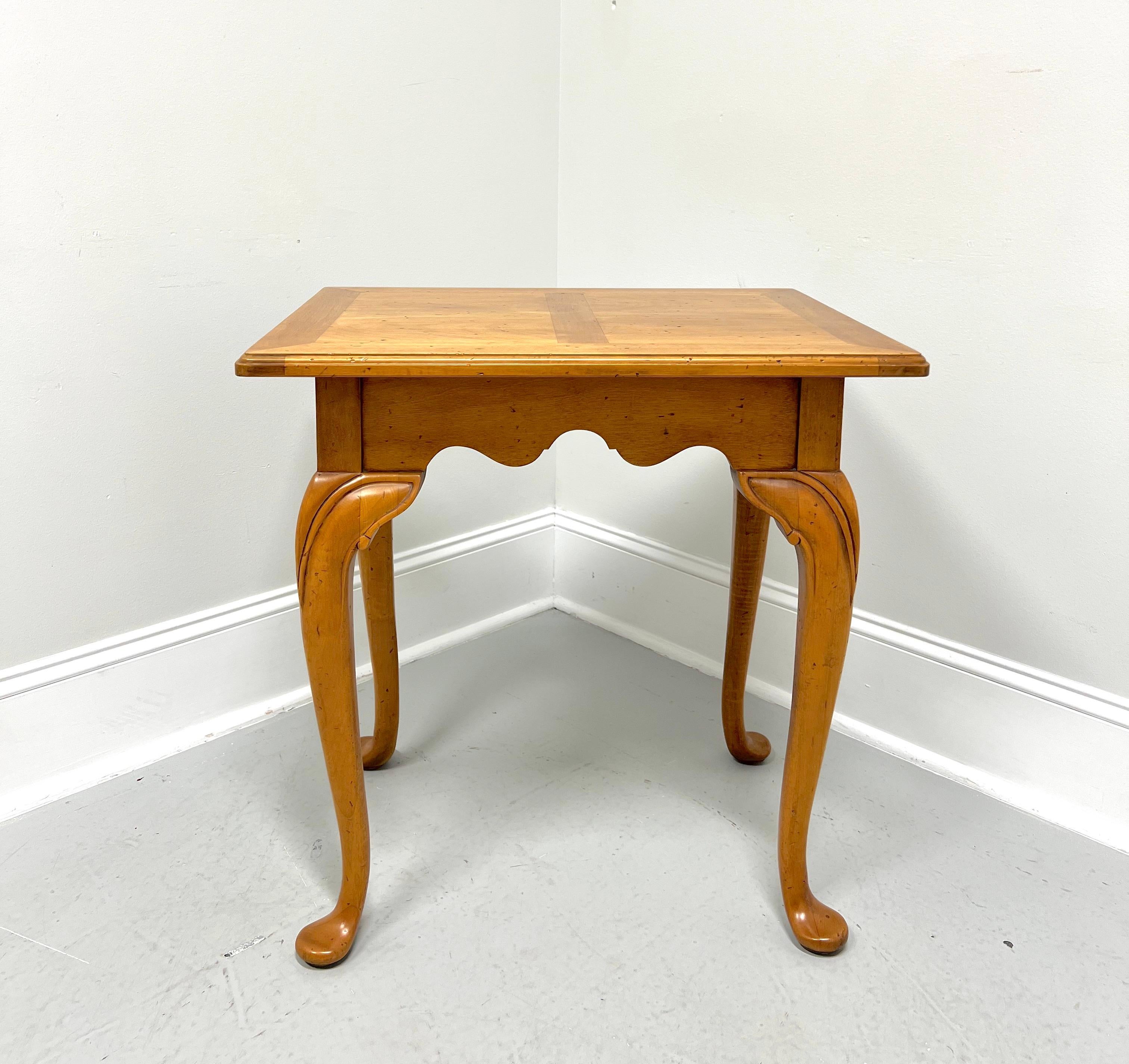 A Cottage / Farmhouse style accent table, unbranded, possibly Hickory Chair or Henredon. Maple with a banded ogee edge top, finished on all sides, carved apron, carved knees, cabriole legs, and pad feet. Made in the USA, in the late 20th