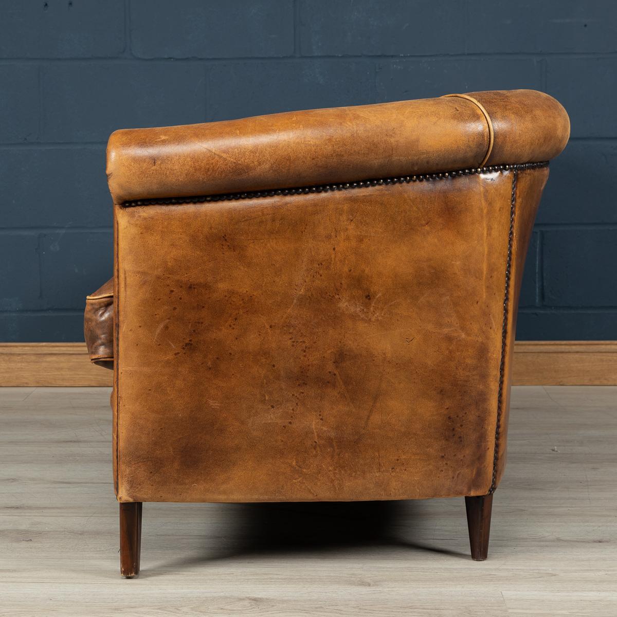 A wonderful leather two-seat sofa in rich tan leather, north European (probably Dutch), mid-late 20th century.

Please note that our interior pieces are located at our interior design showroom in Buckinghamshire.
 